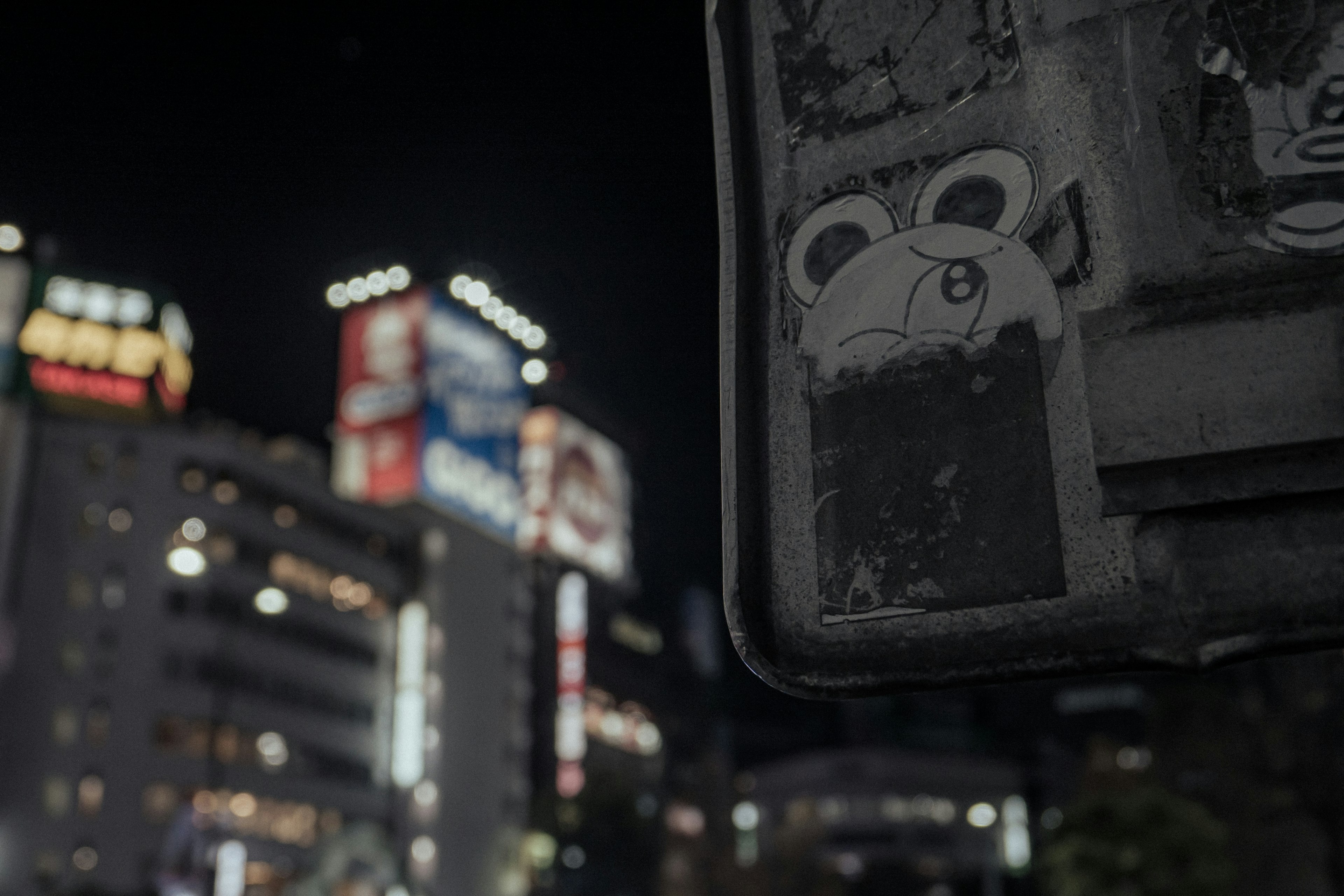 Urban night scene featuring a vintage sign with artistic graffiti