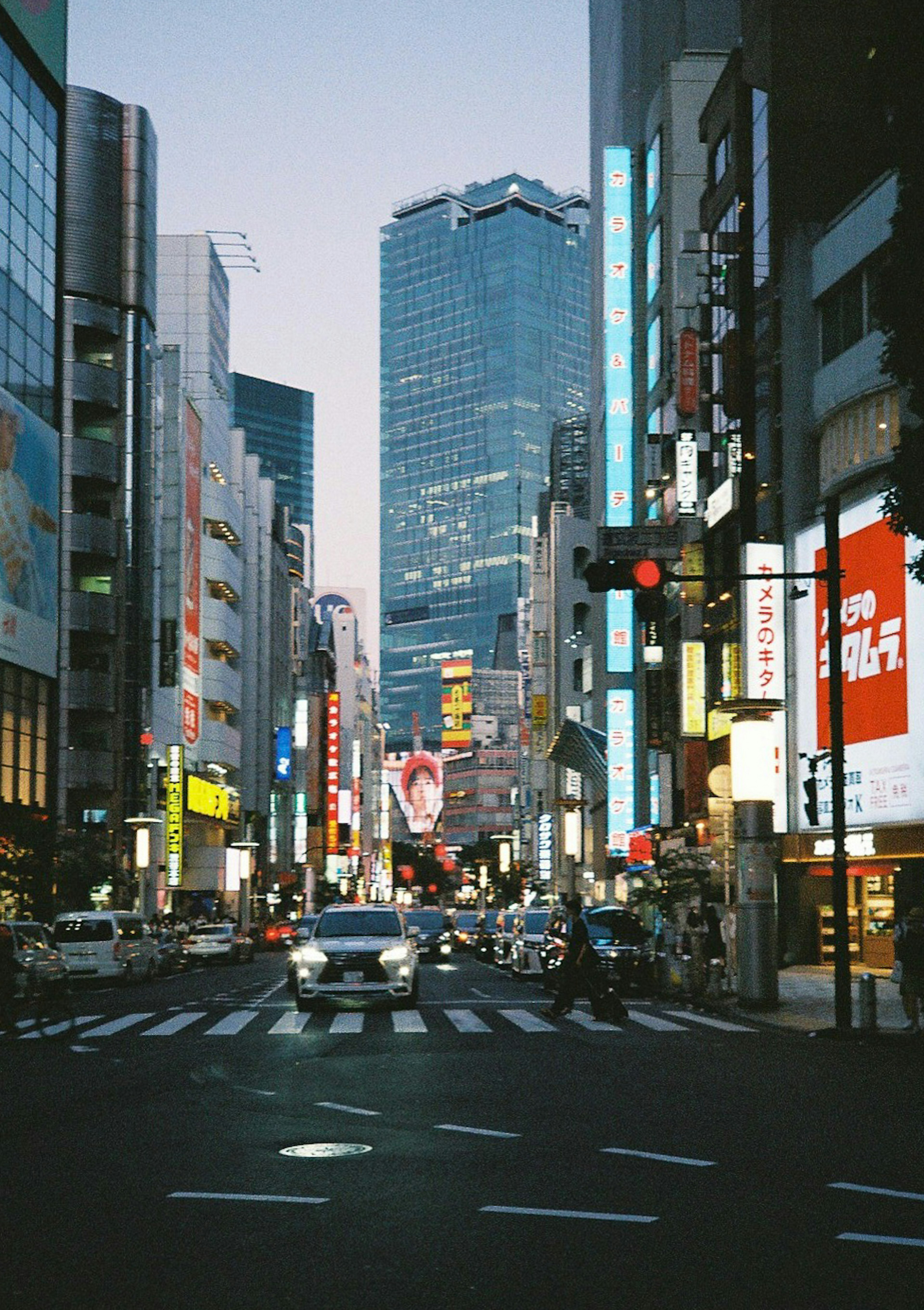 Urban streetscape featuring skyscrapers and evening lights