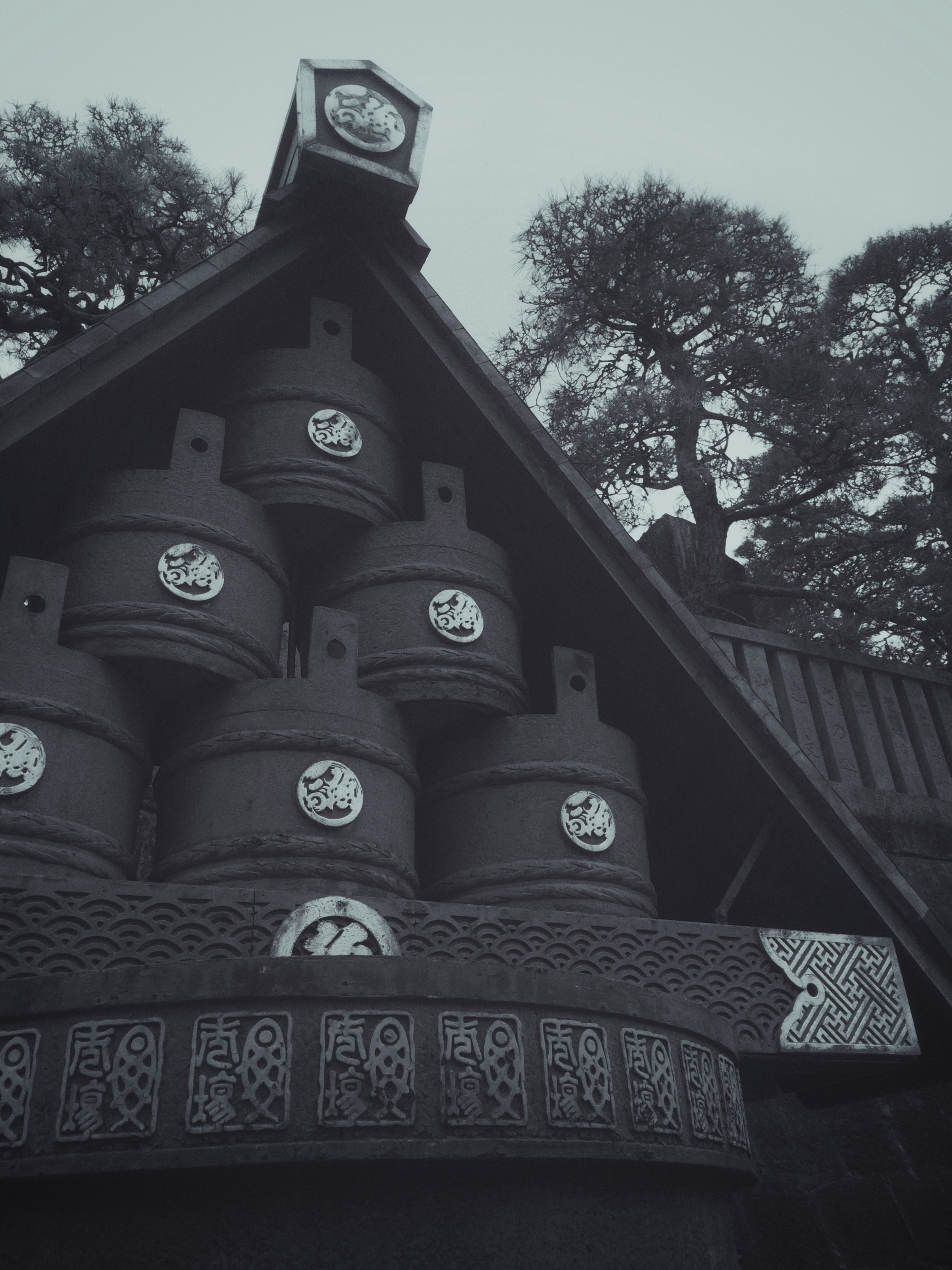 Toit d'un bâtiment traditionnel avec de grands fûts et des horloges en tons noir et blanc