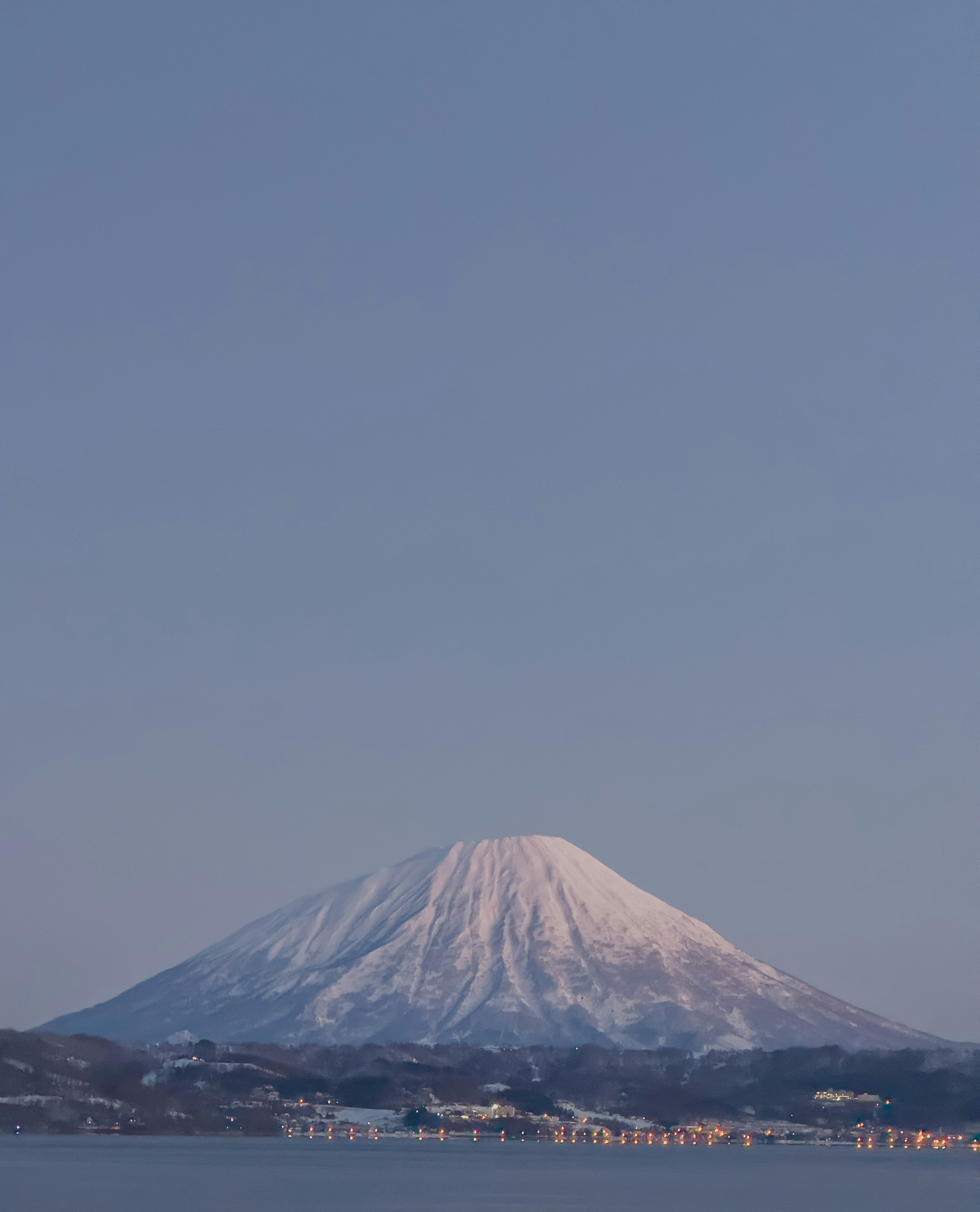 Snow-covered mountain under a clear blue sky