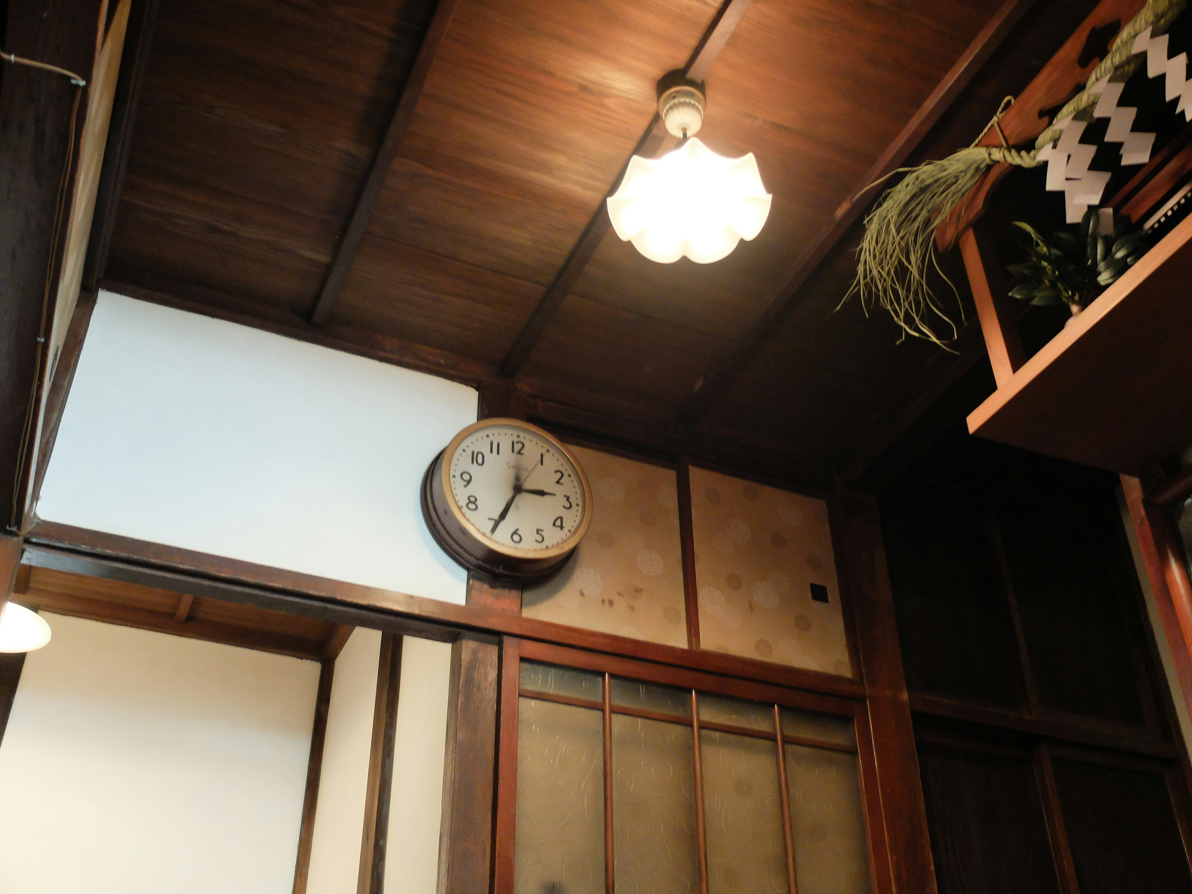 Traditional Japanese interior featuring wooden ceiling and vintage clock