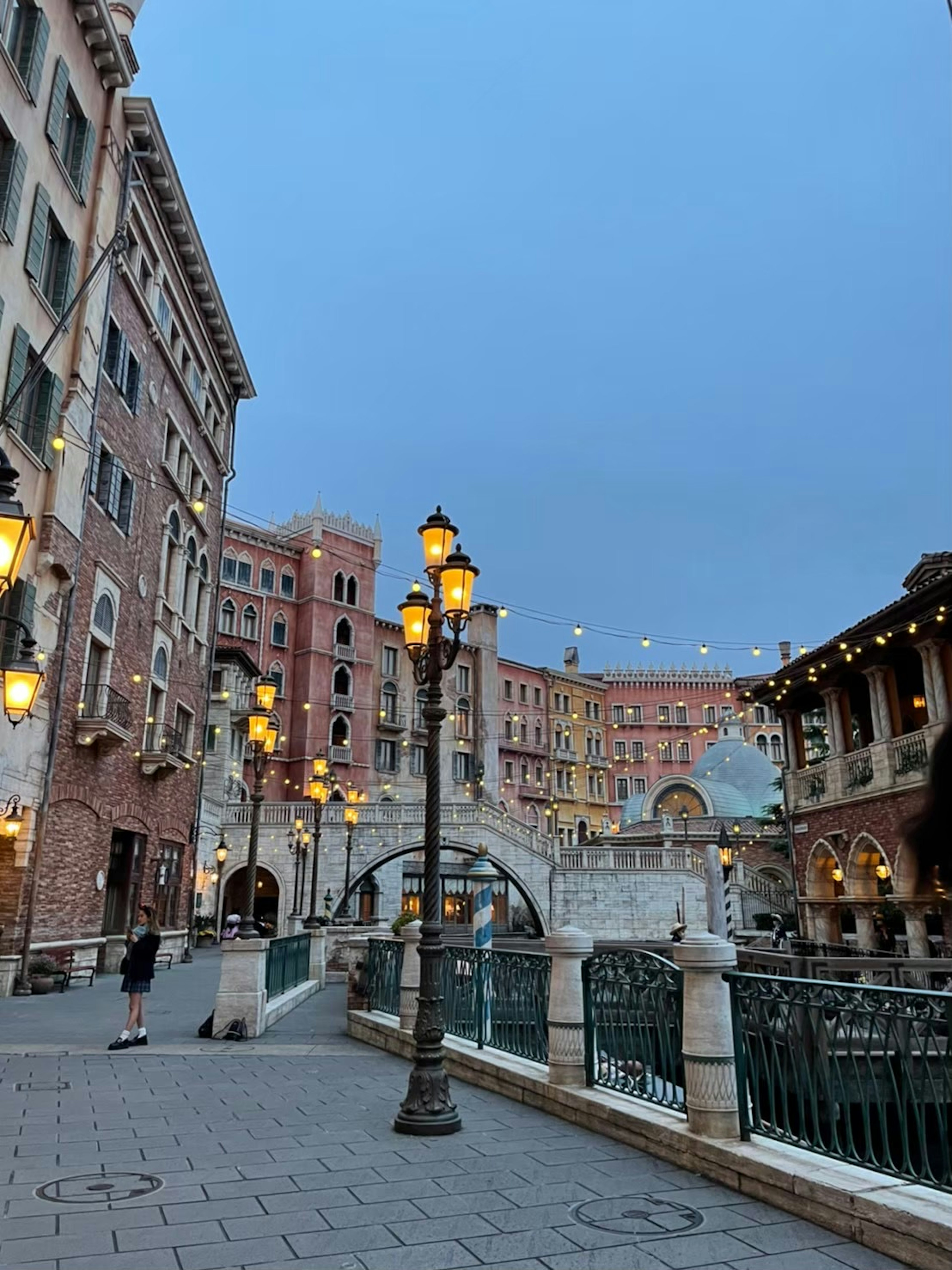 Charming canal-side street scene with vintage street lamps at dusk