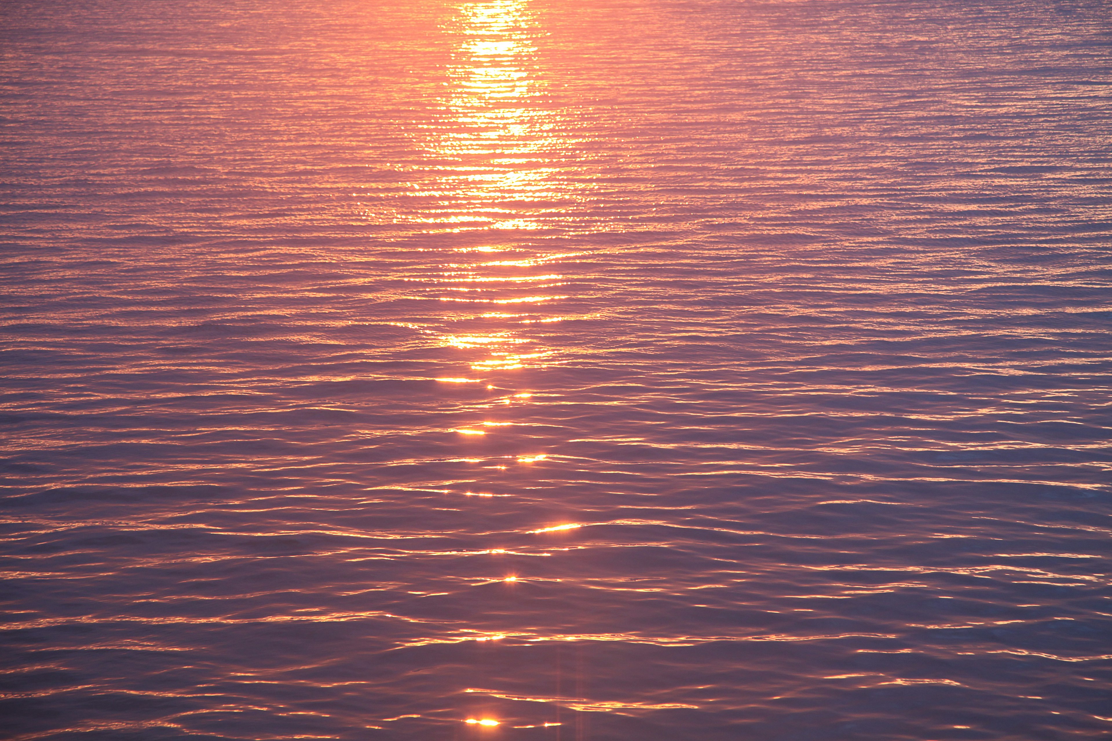 Sunset reflections on a calm water surface