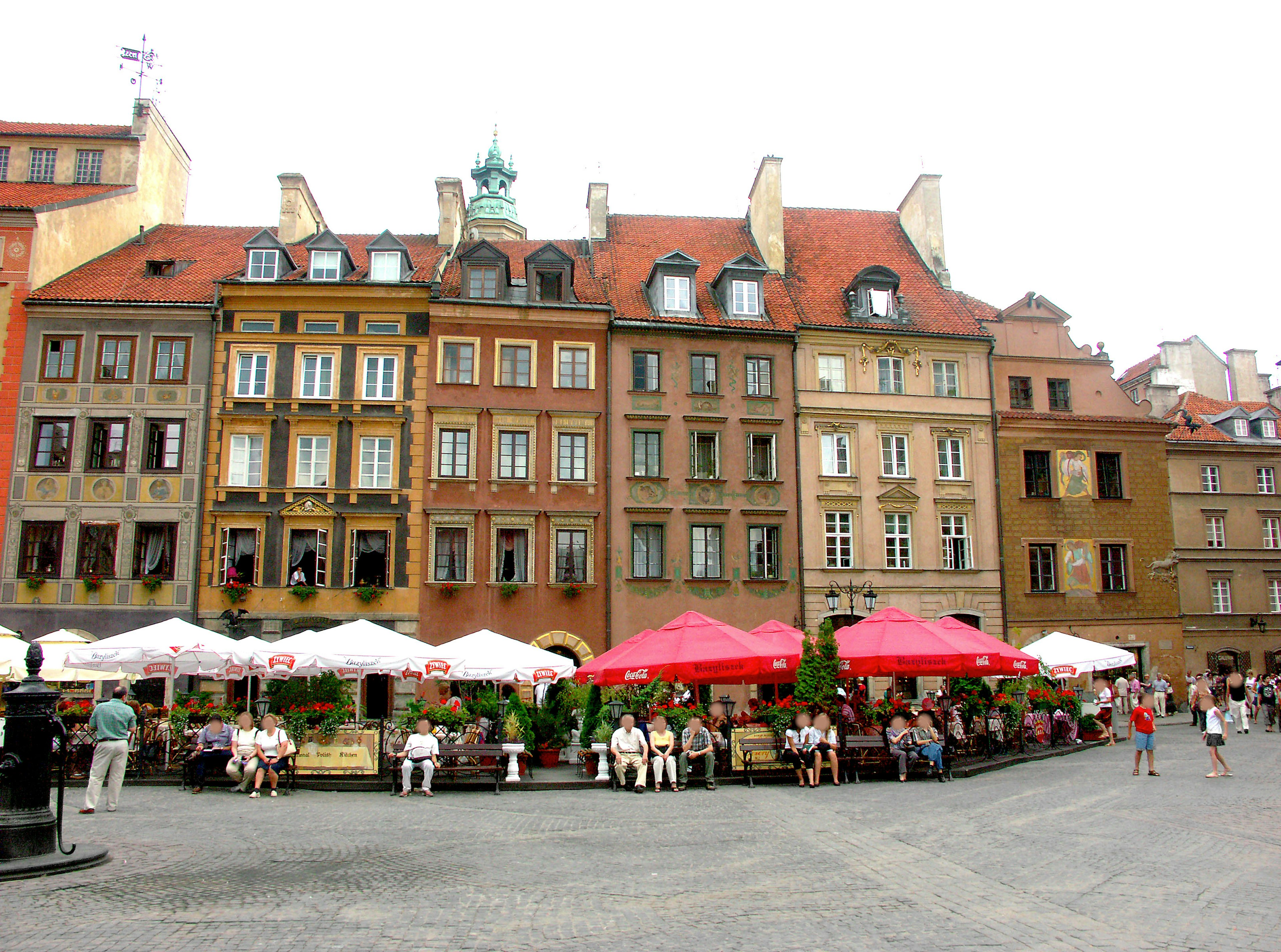 Colorful buildings and café terraces in Warsaw's Old Town Square