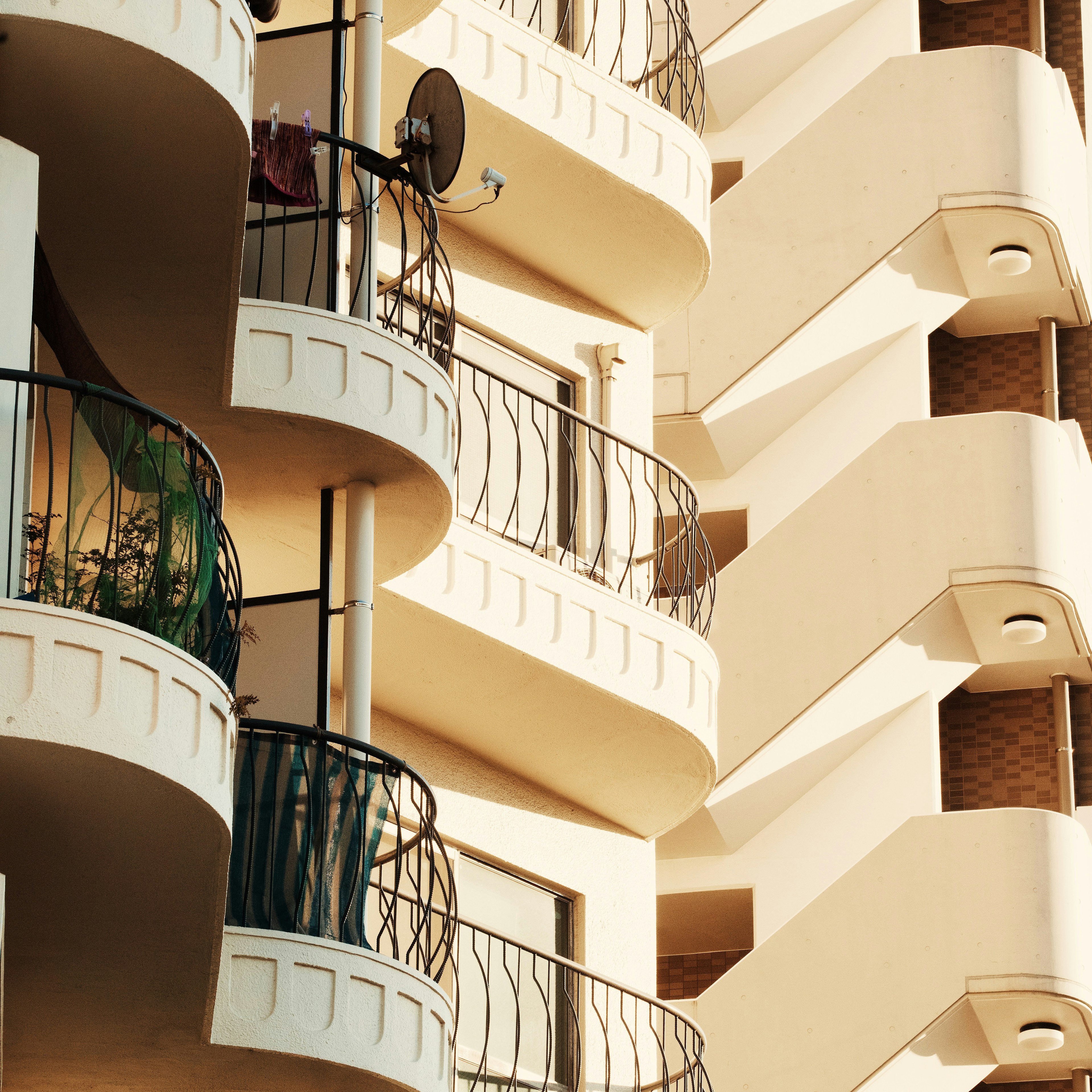 Exterior view of a building featuring intricate balconies and staircases