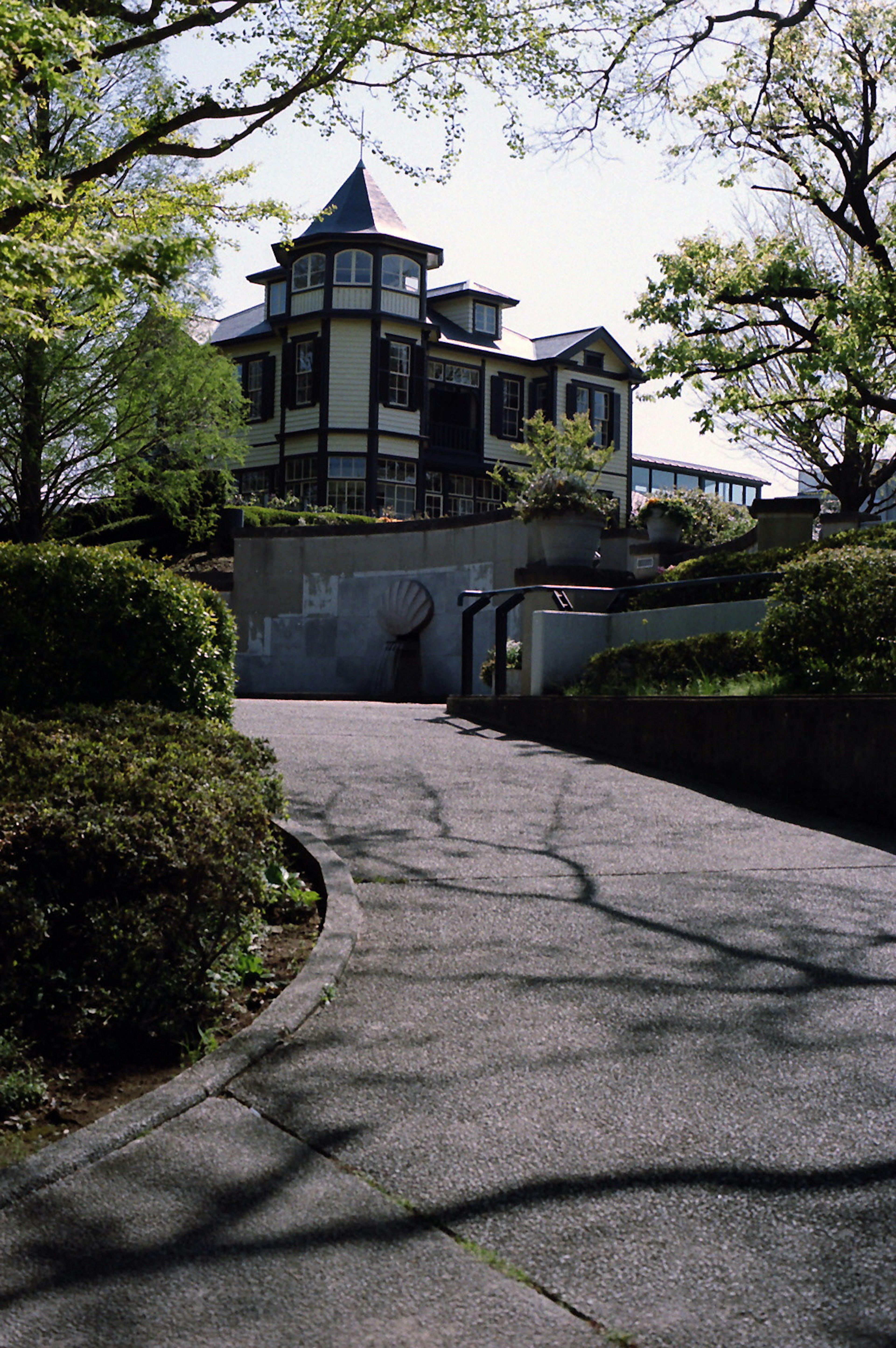 A beautiful mansion surrounded by greenery on a hillside