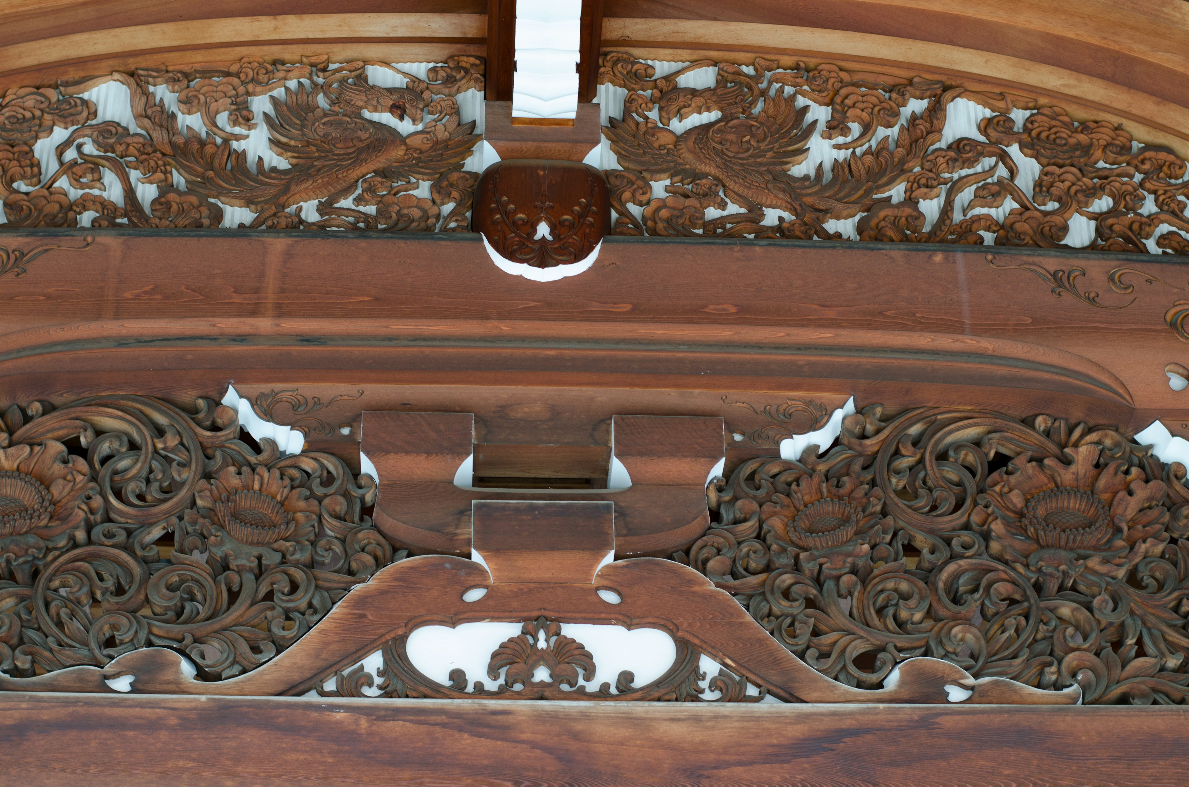 Decorative wooden beam with intricate carvings on the ceiling