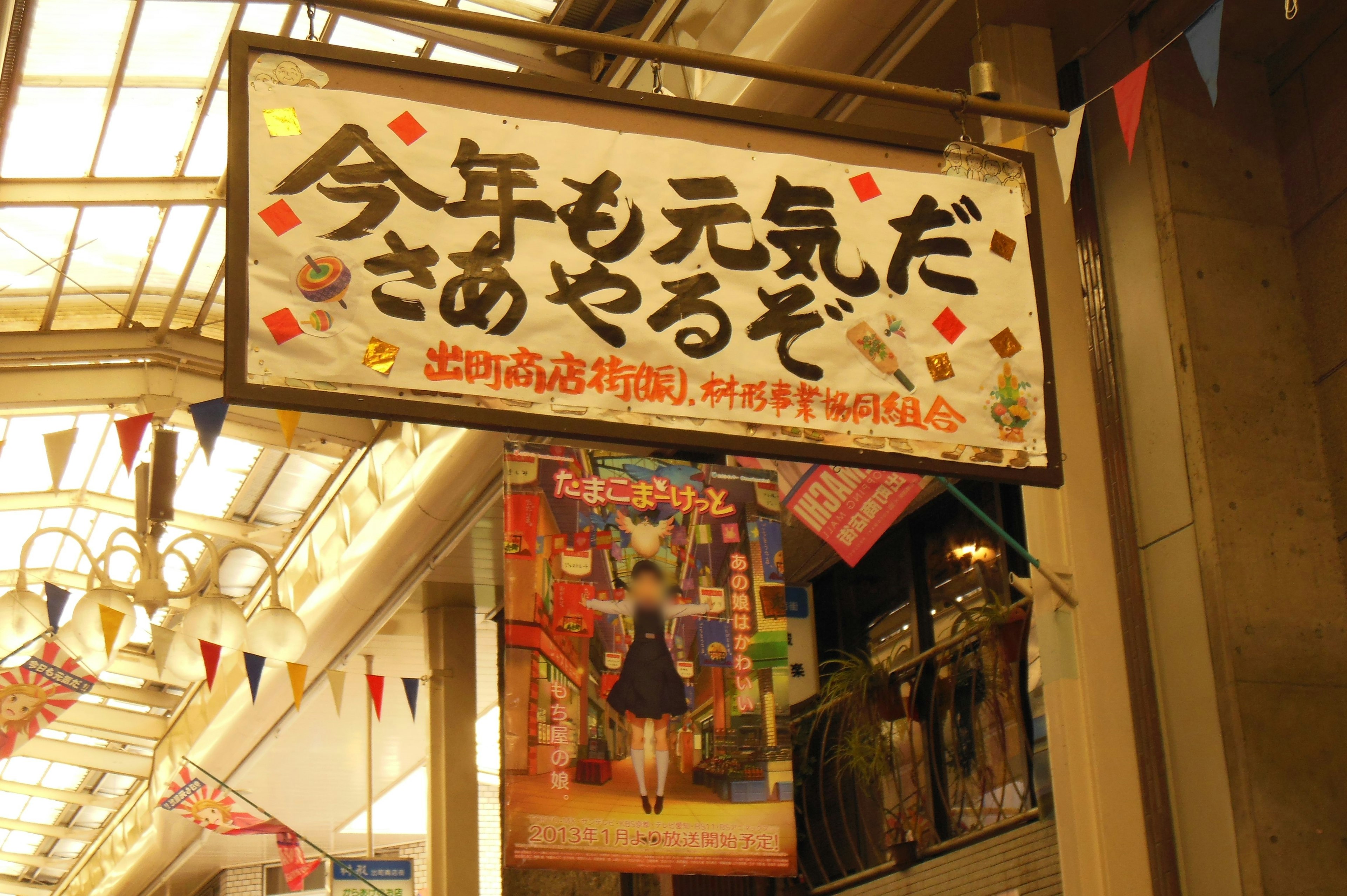 A vibrant sign in a shopping arcade with colorful decorations