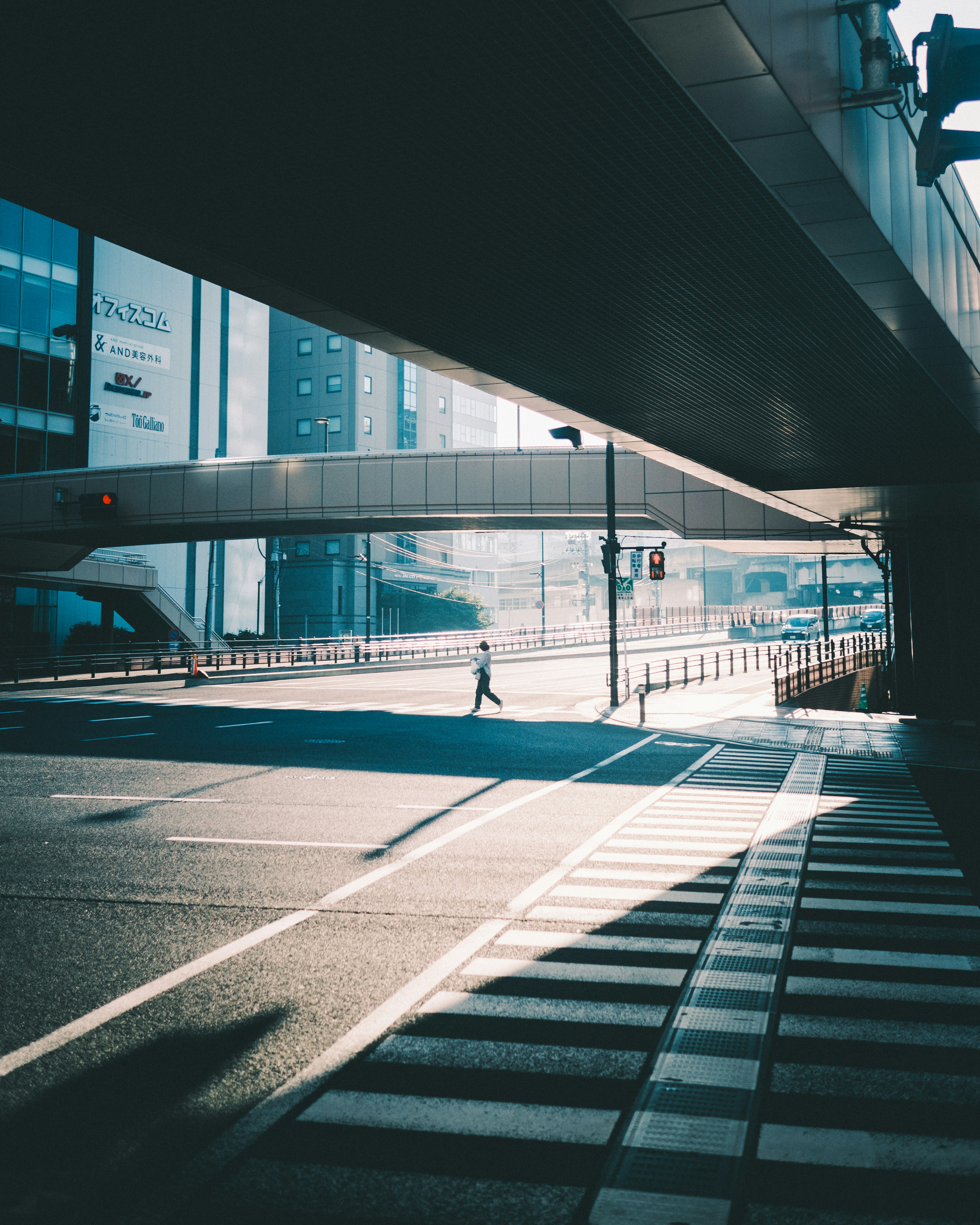 Urban scene featuring a crosswalk and a silhouette of a pedestrian