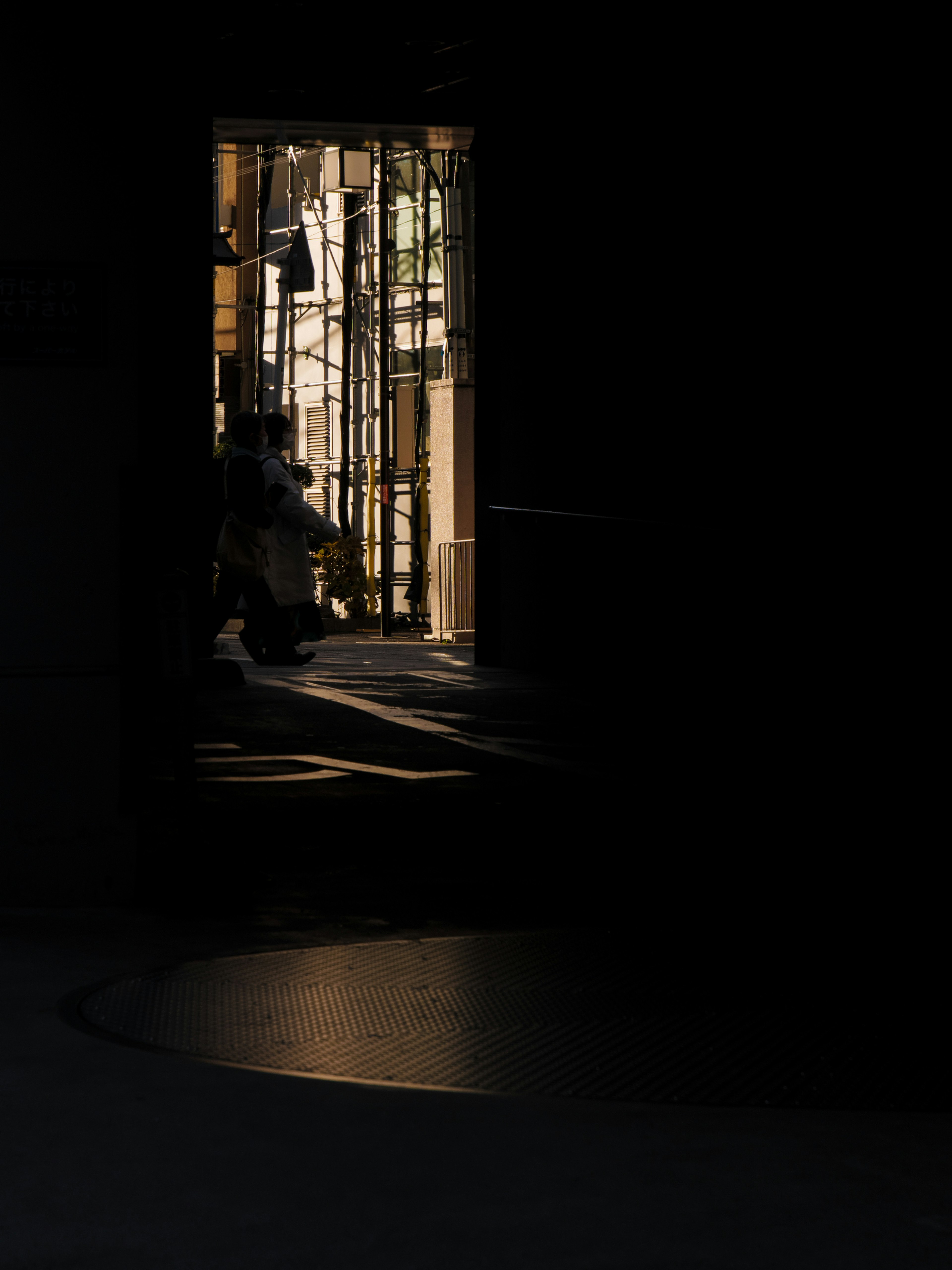 A bright doorway illuminated against a dark background