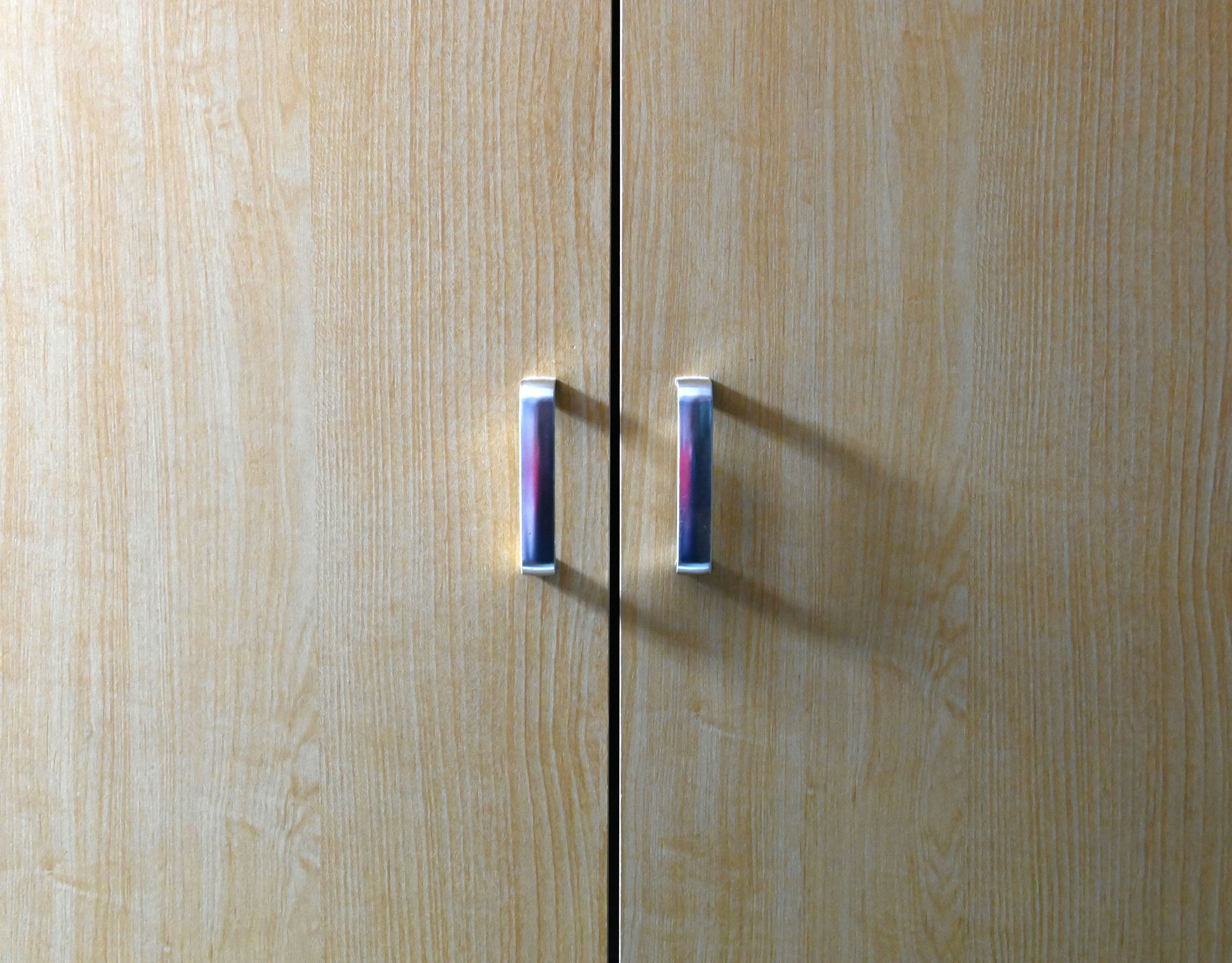 Wooden cabinet doors with blue and purple handles