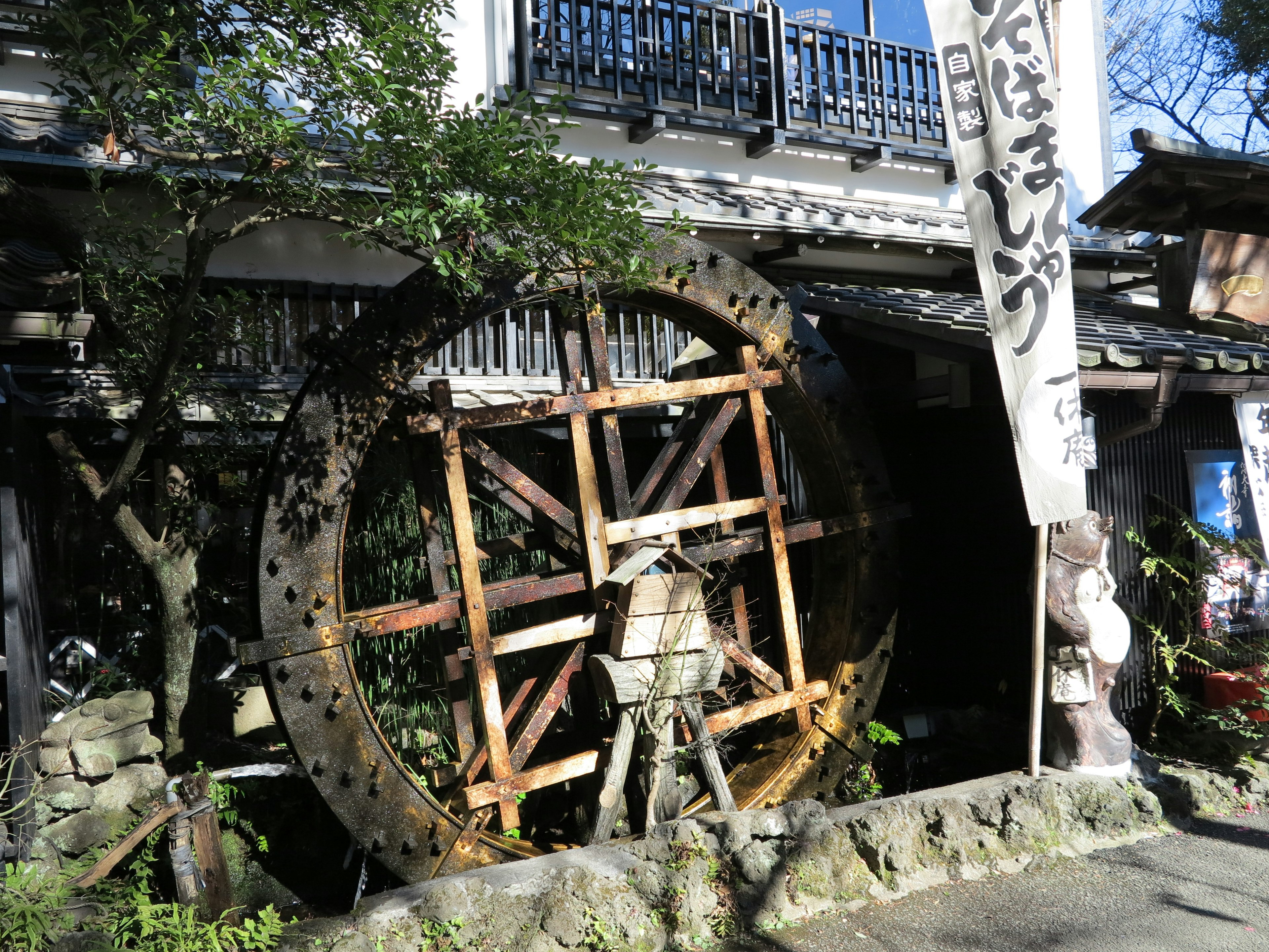 An old water wheel surrounded by greenery