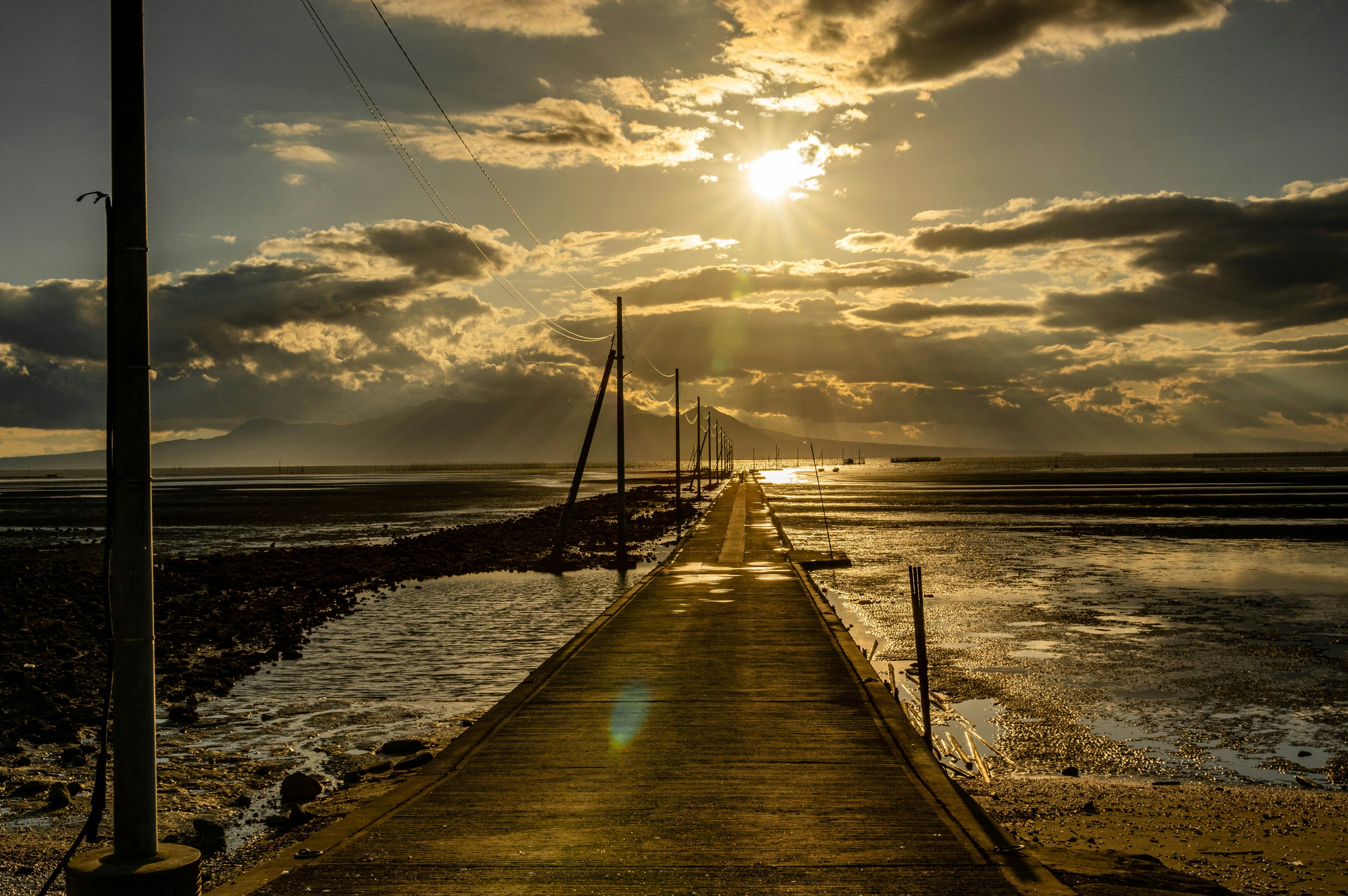 Ponton pittoresque au coucher du soleil avec des nuages et des reflets