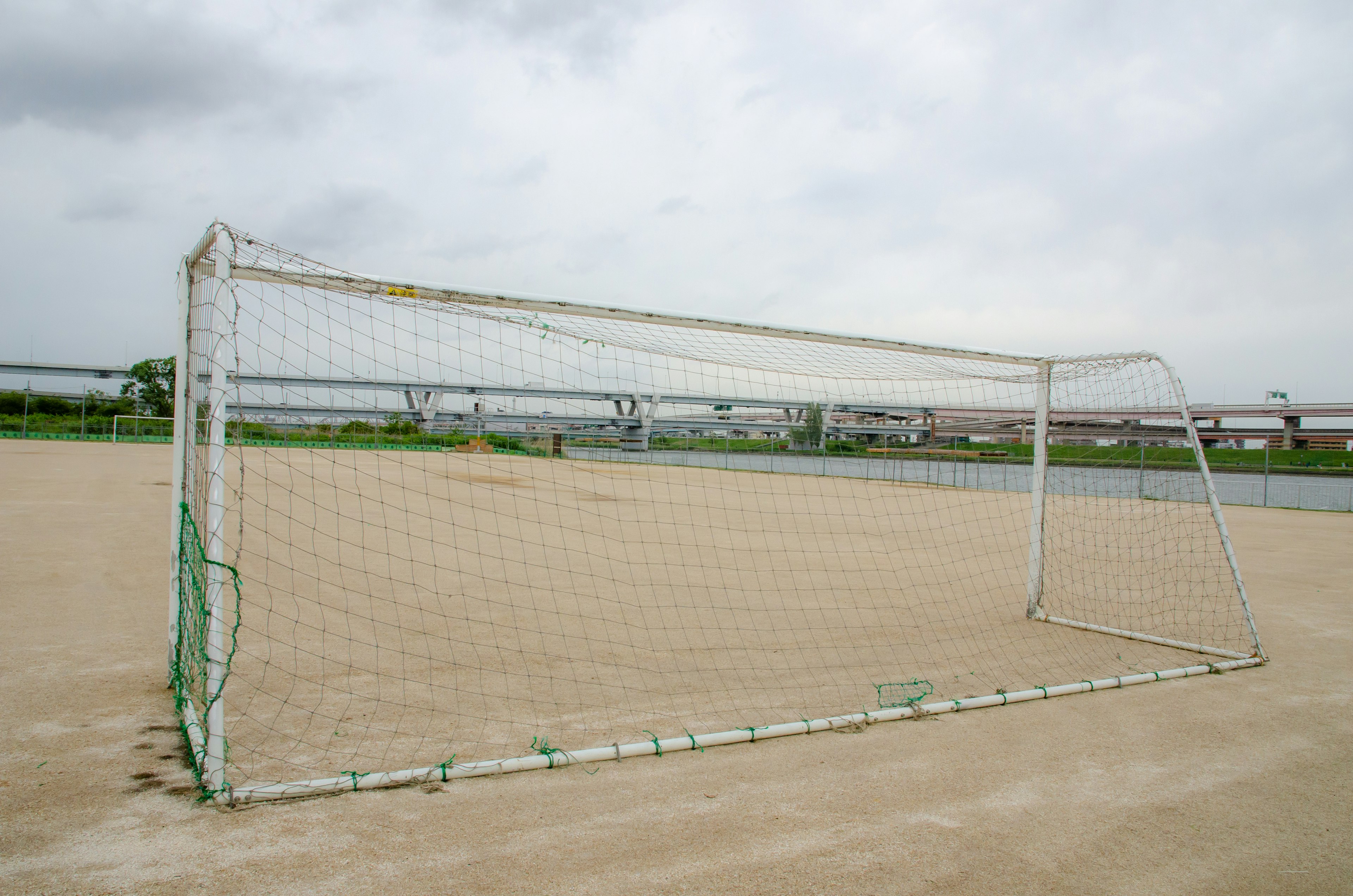 Soccer goal standing under a cloudy sky