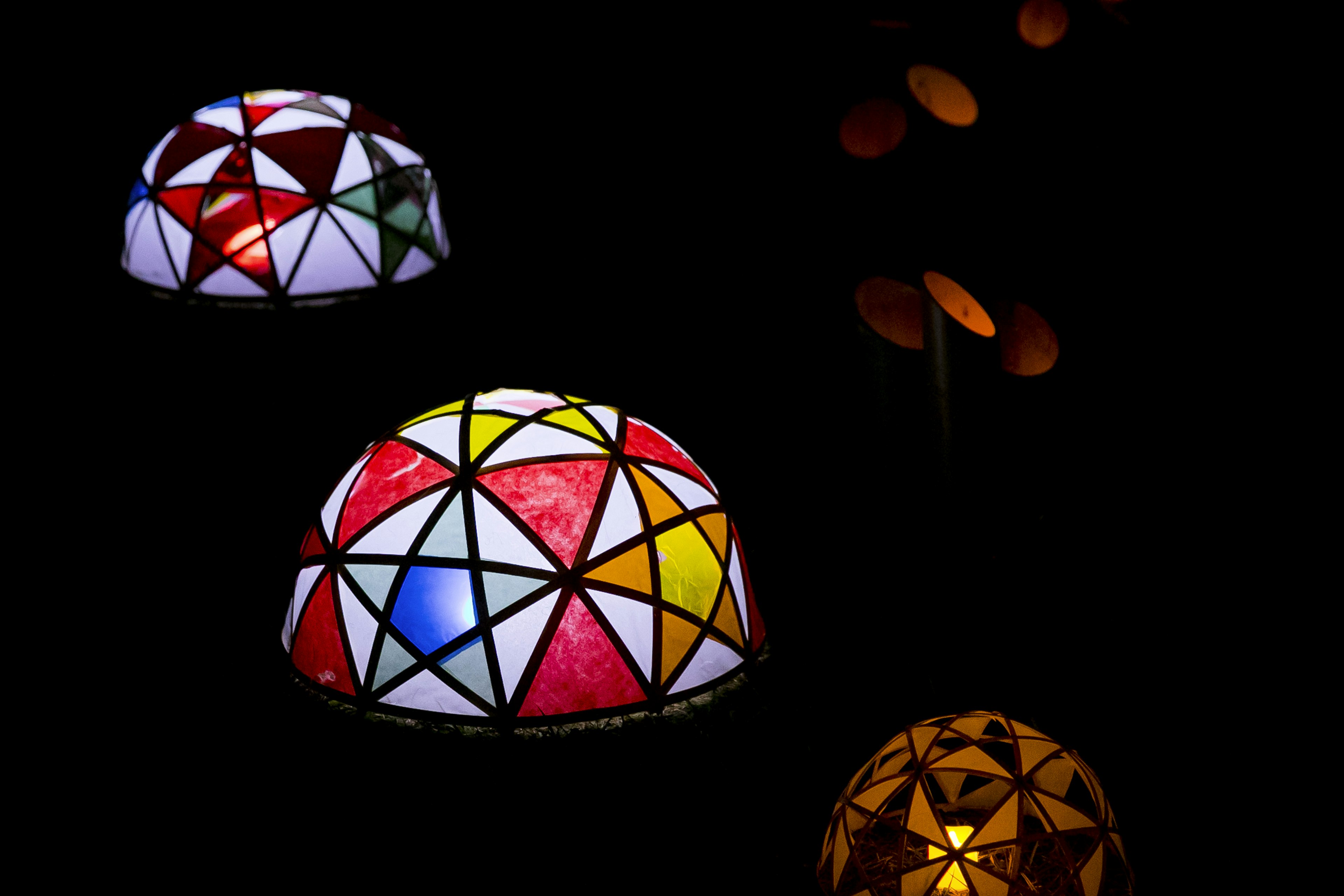 Colorful dome-shaped light fixtures glowing in the dark