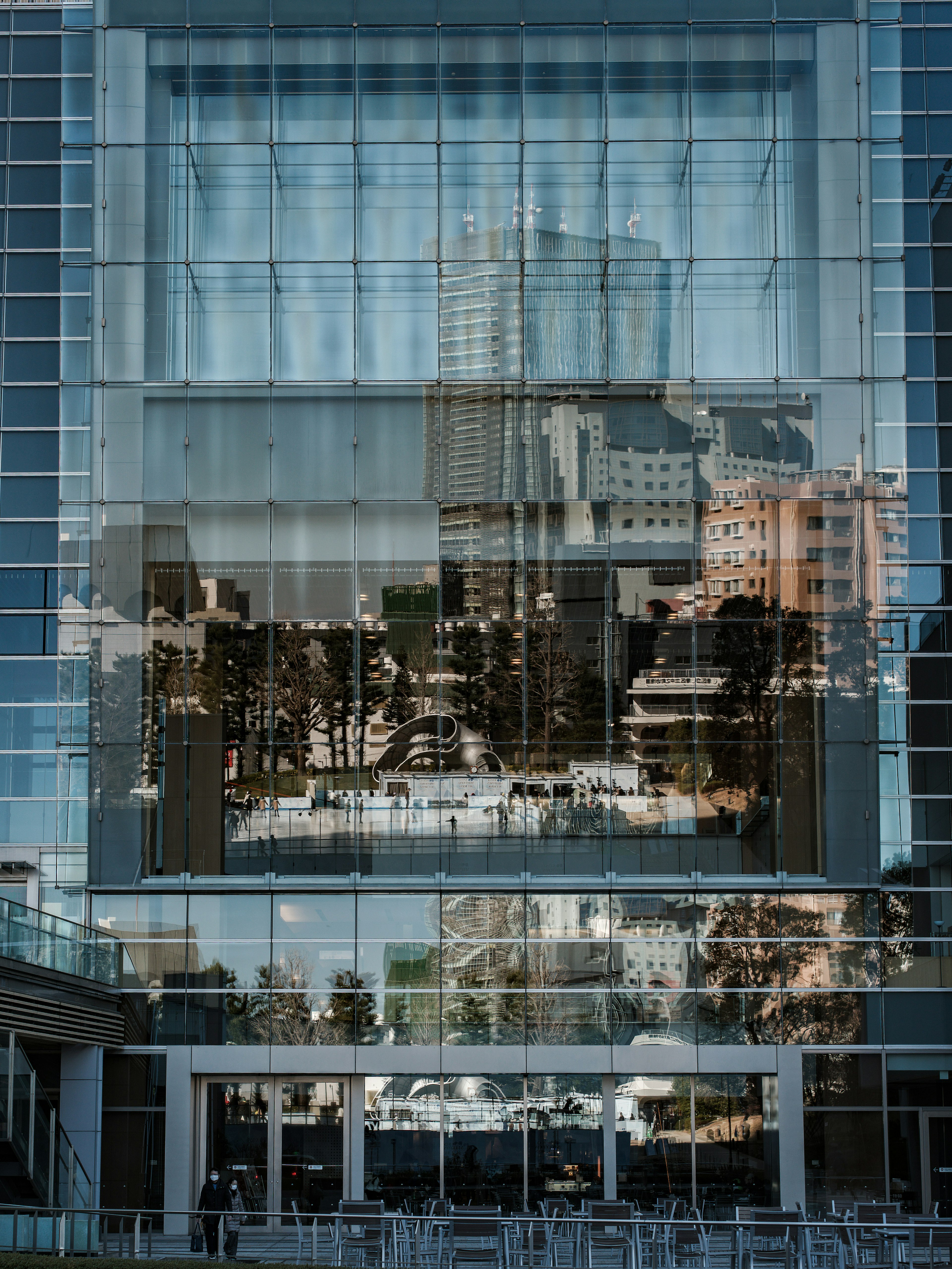 Image capturing the reflection of a modern building with glass facade