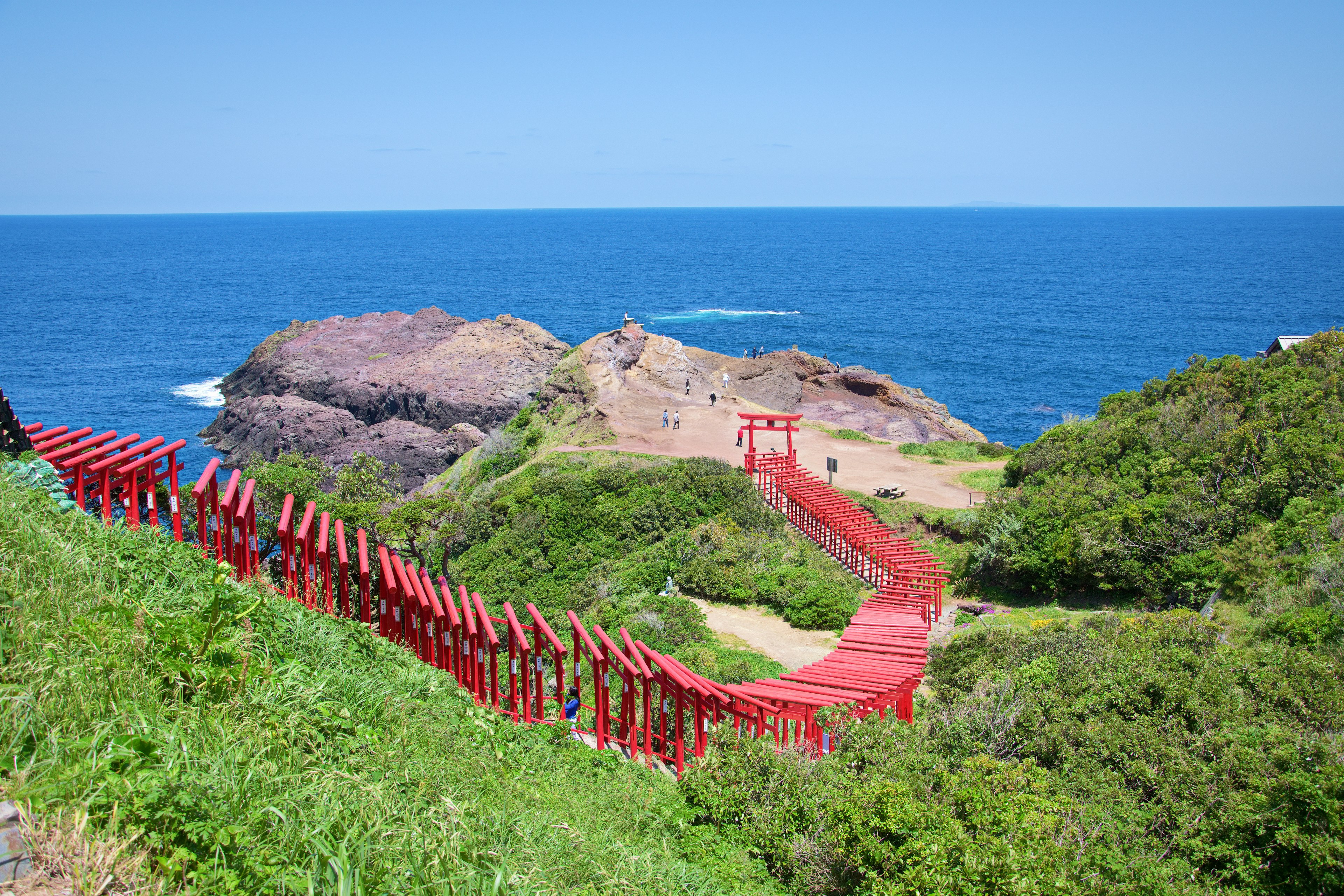 Scenic view featuring a blue ocean and a red bridge