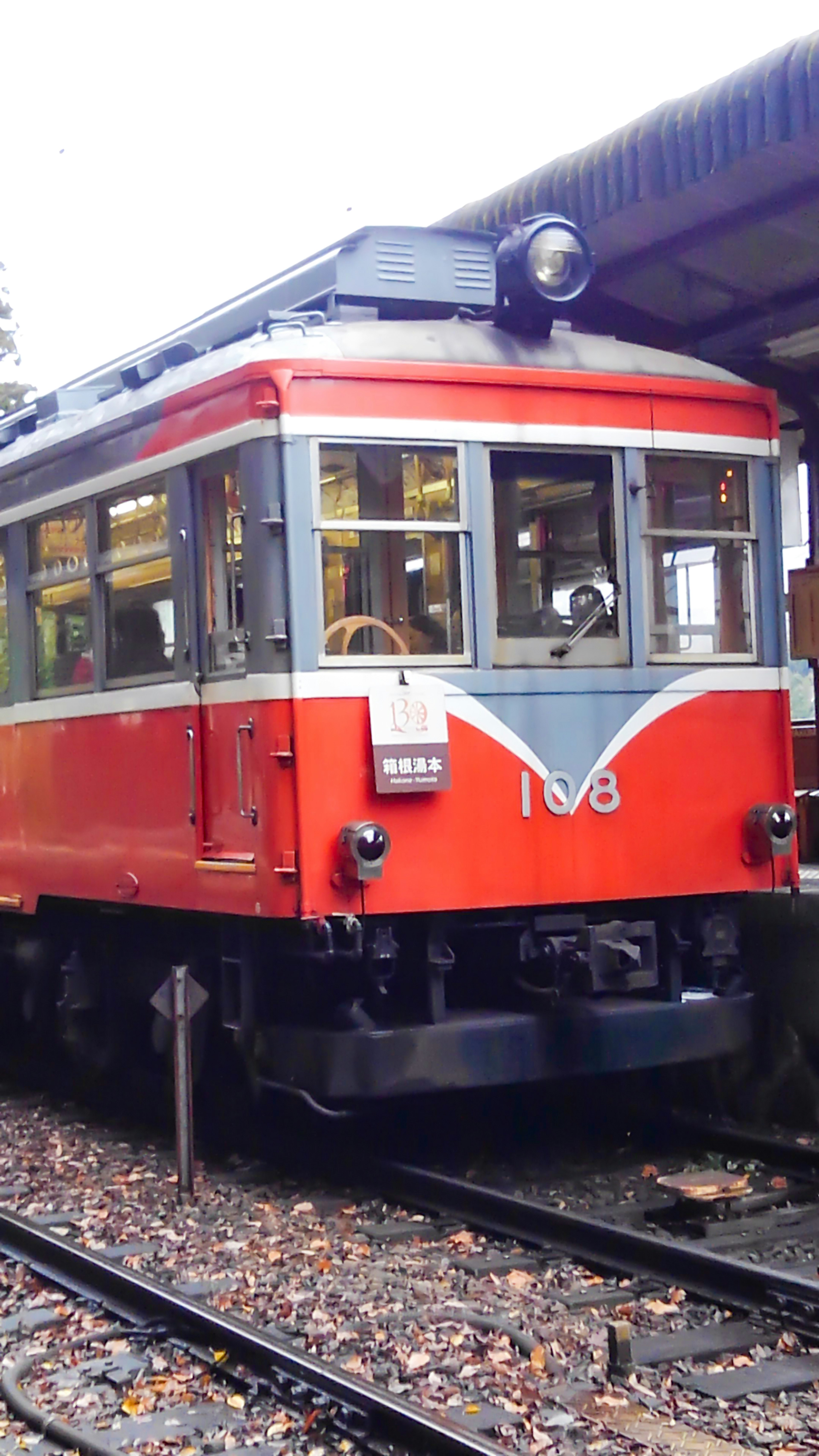 Red vintage train parked at a station