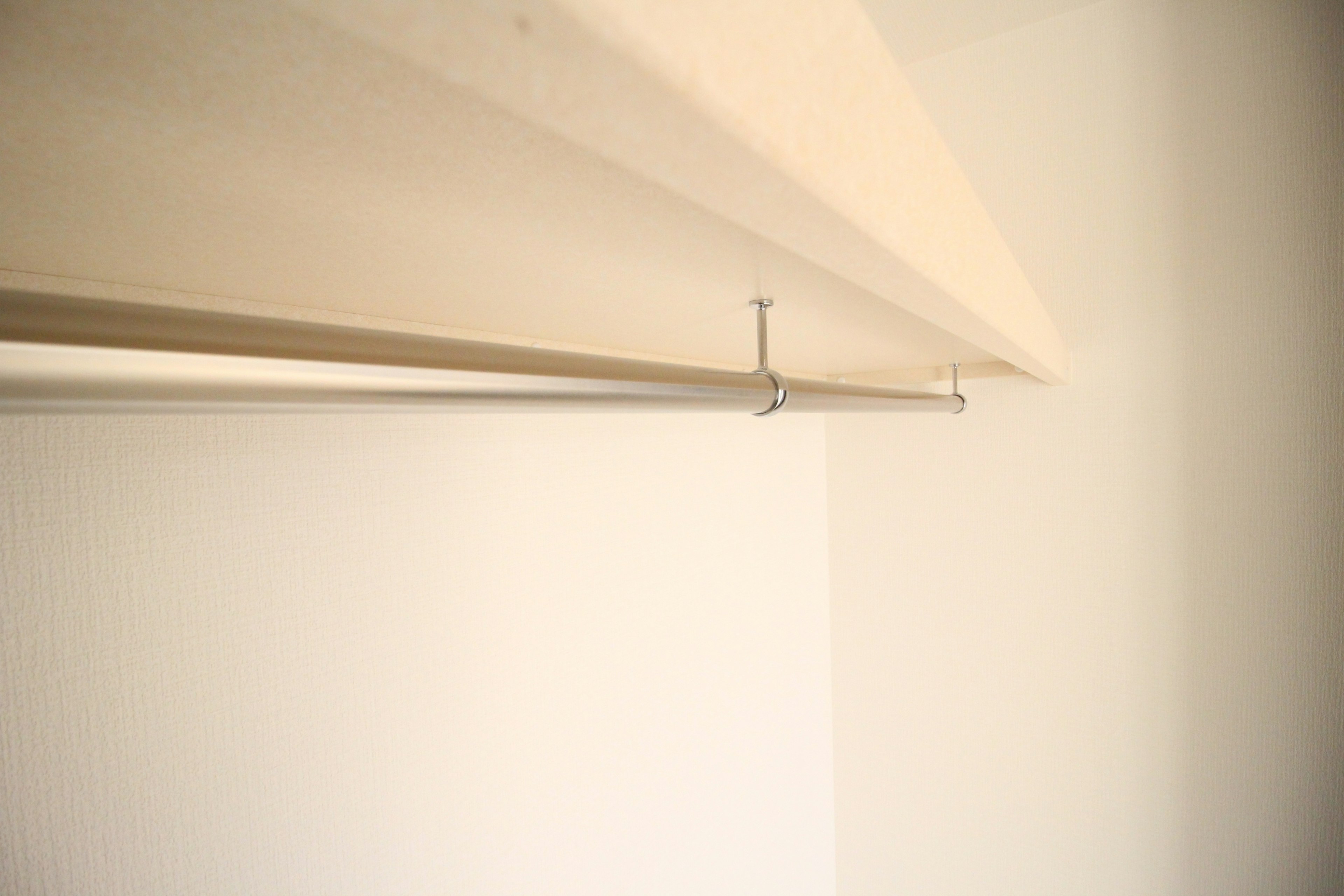 Simple design of a closet rod against a white wall