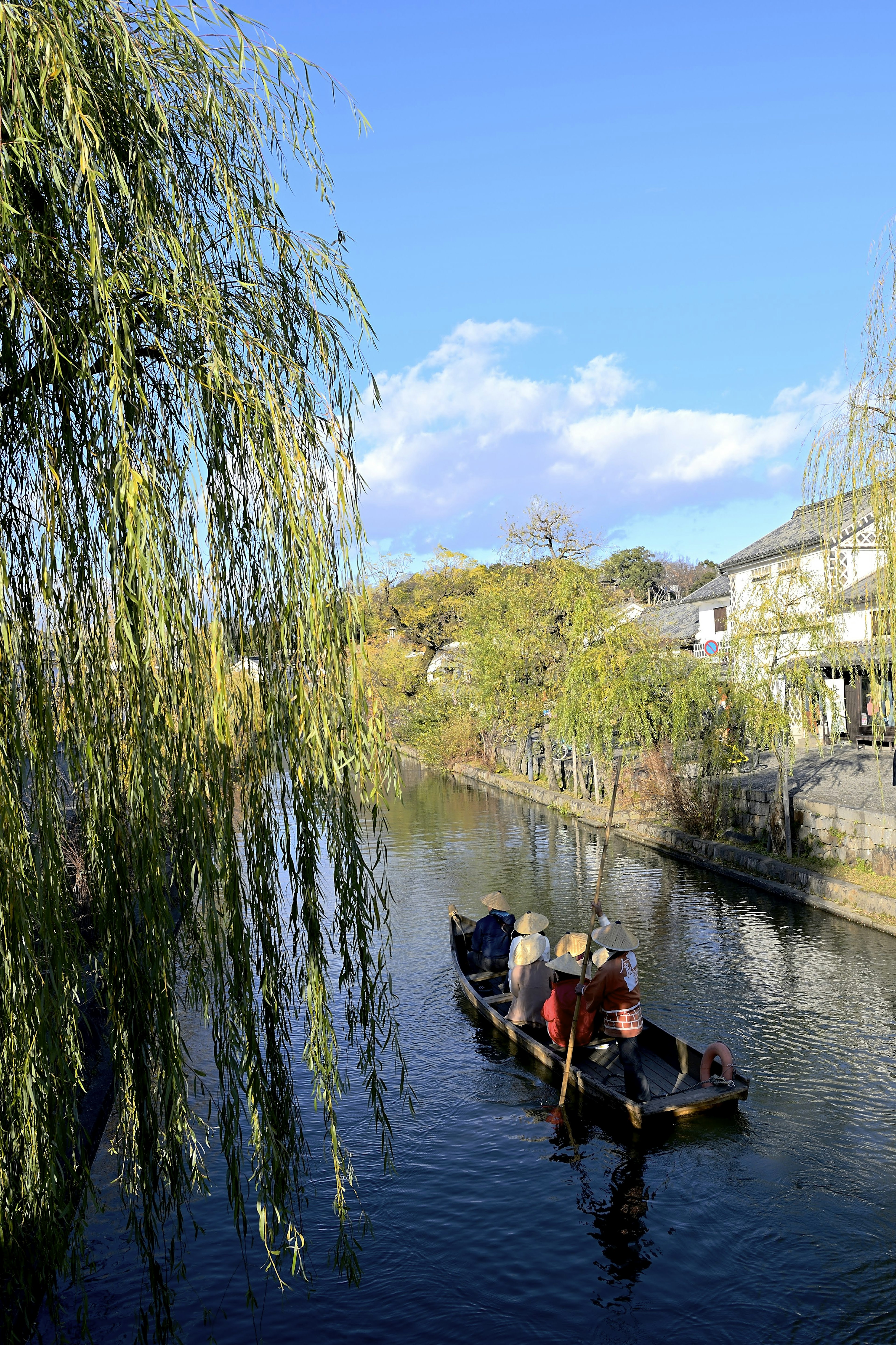 A serene river scene with a boat and willow trees