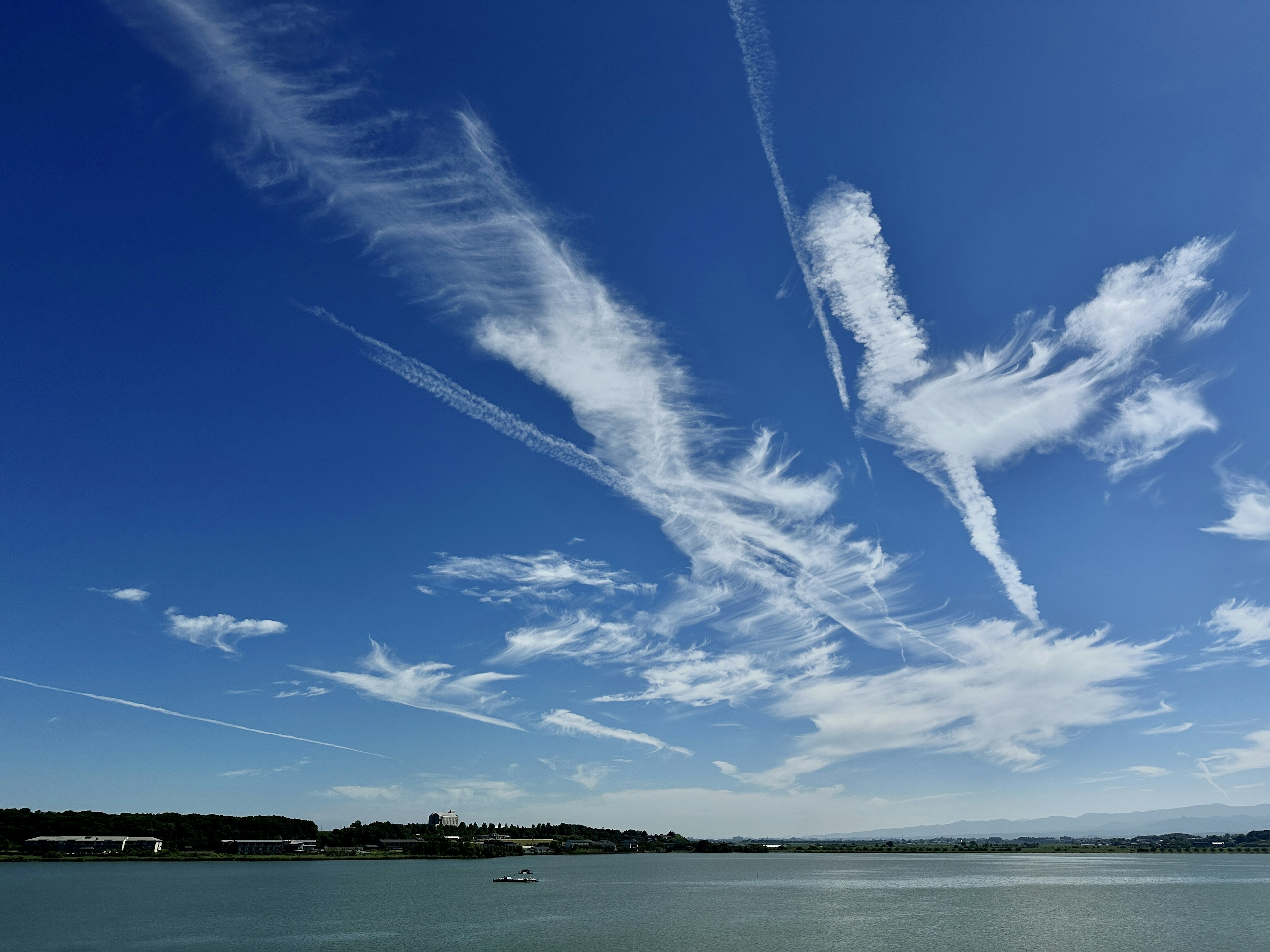 Beautiful view of white clouds and contrails in a blue sky