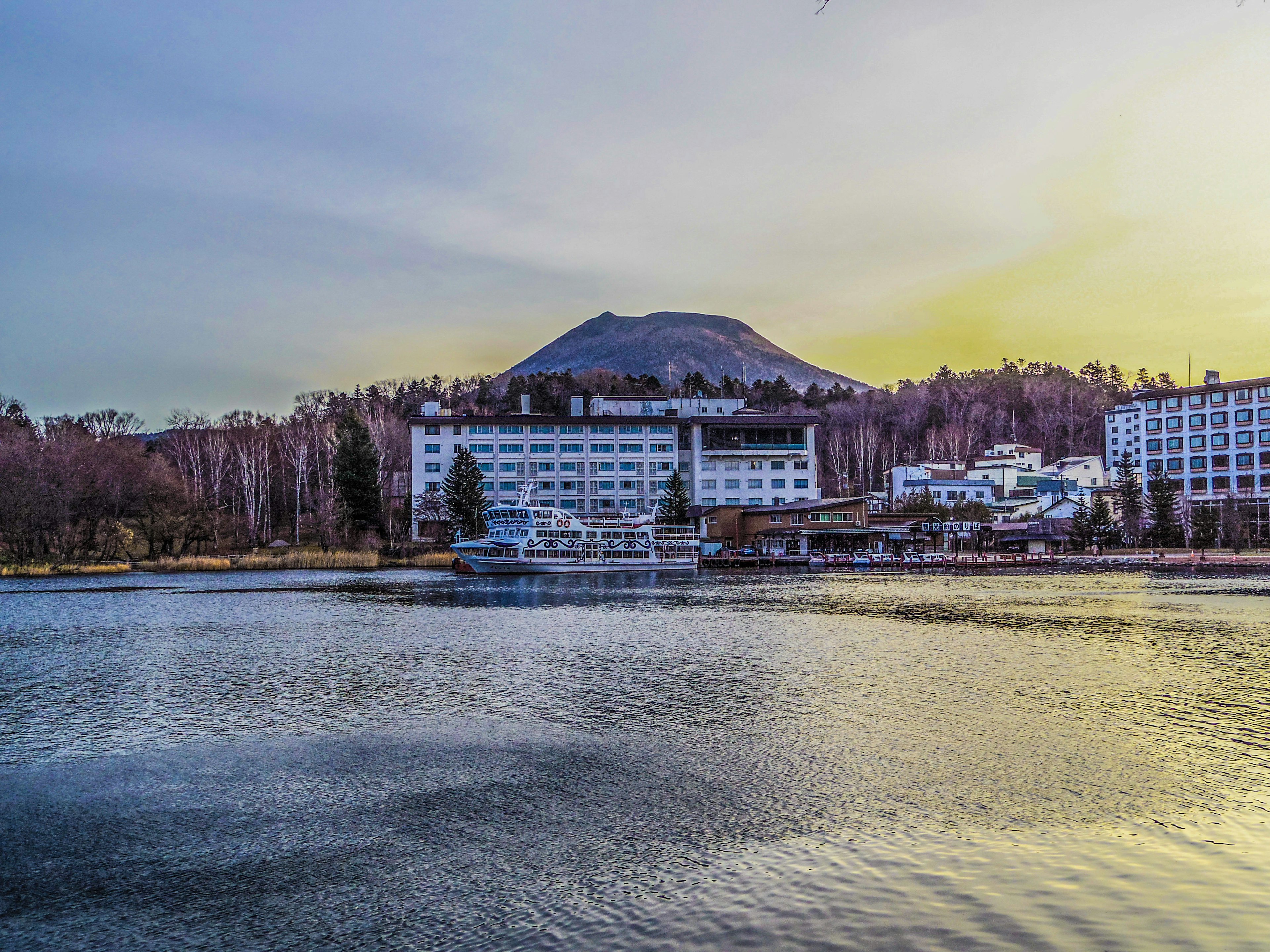 Hotel am Ufer des Sees mit Berg im Hintergrund