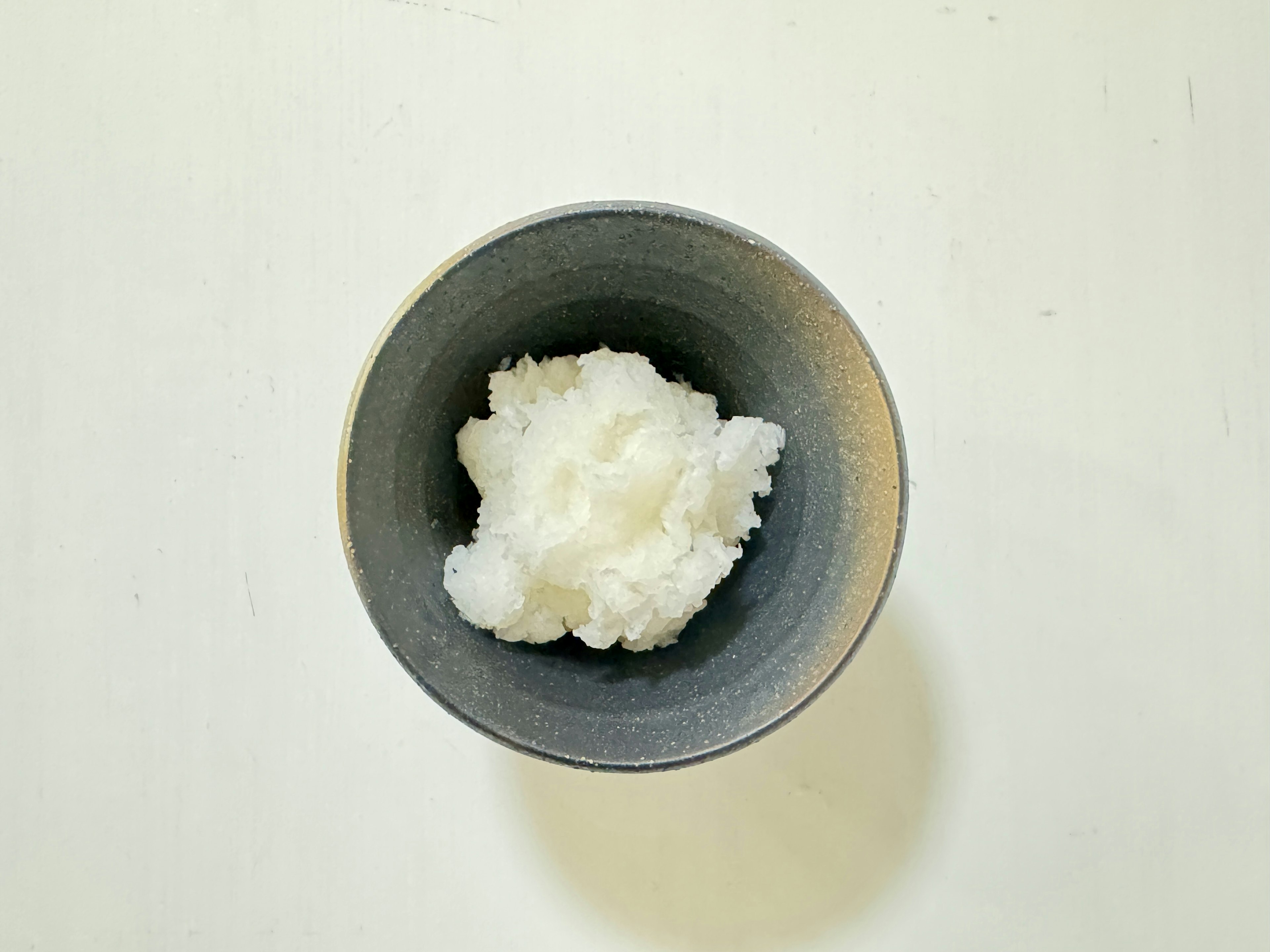 White food item in a gray bowl