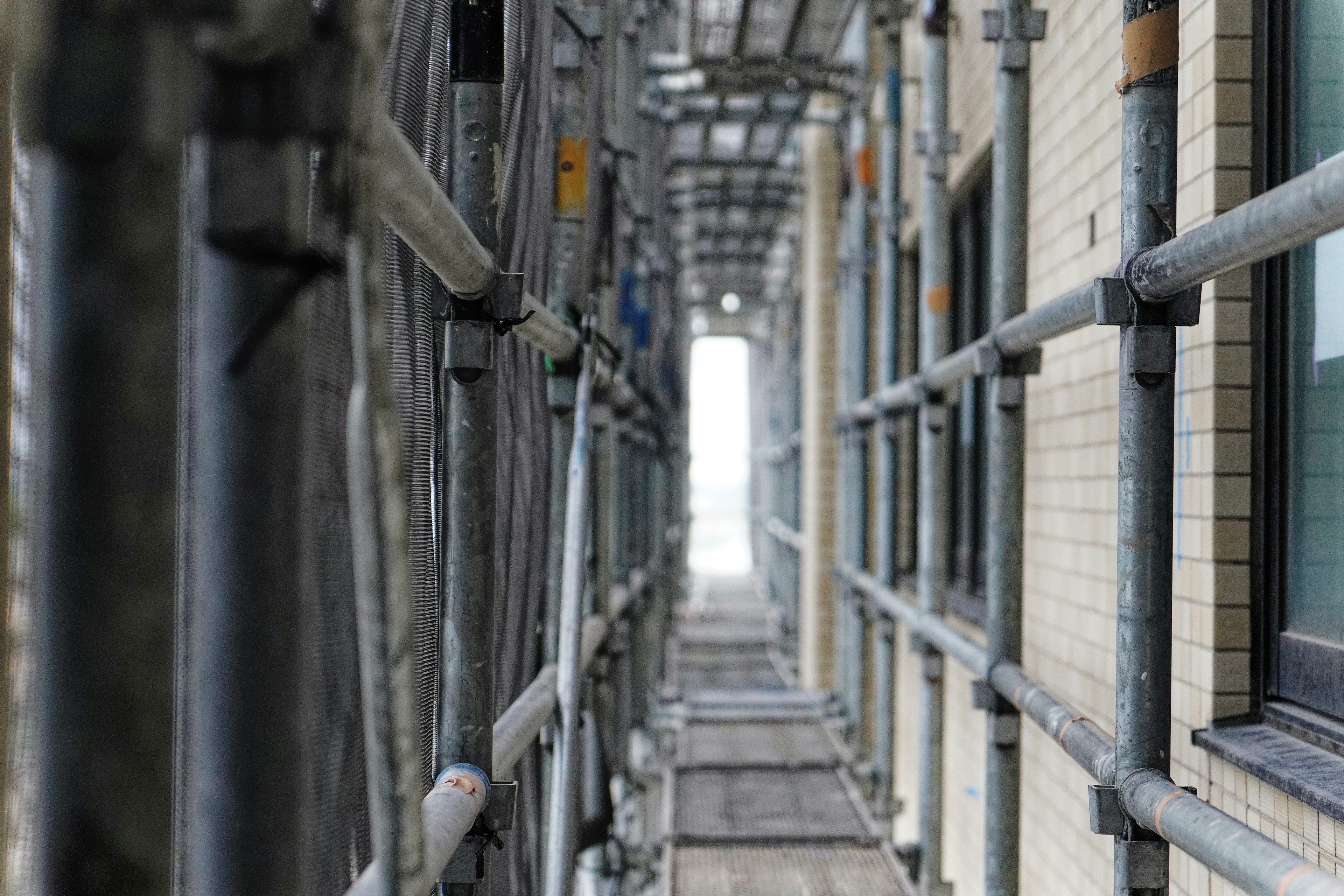 Photo of a scaffolding walkway along a building's exterior