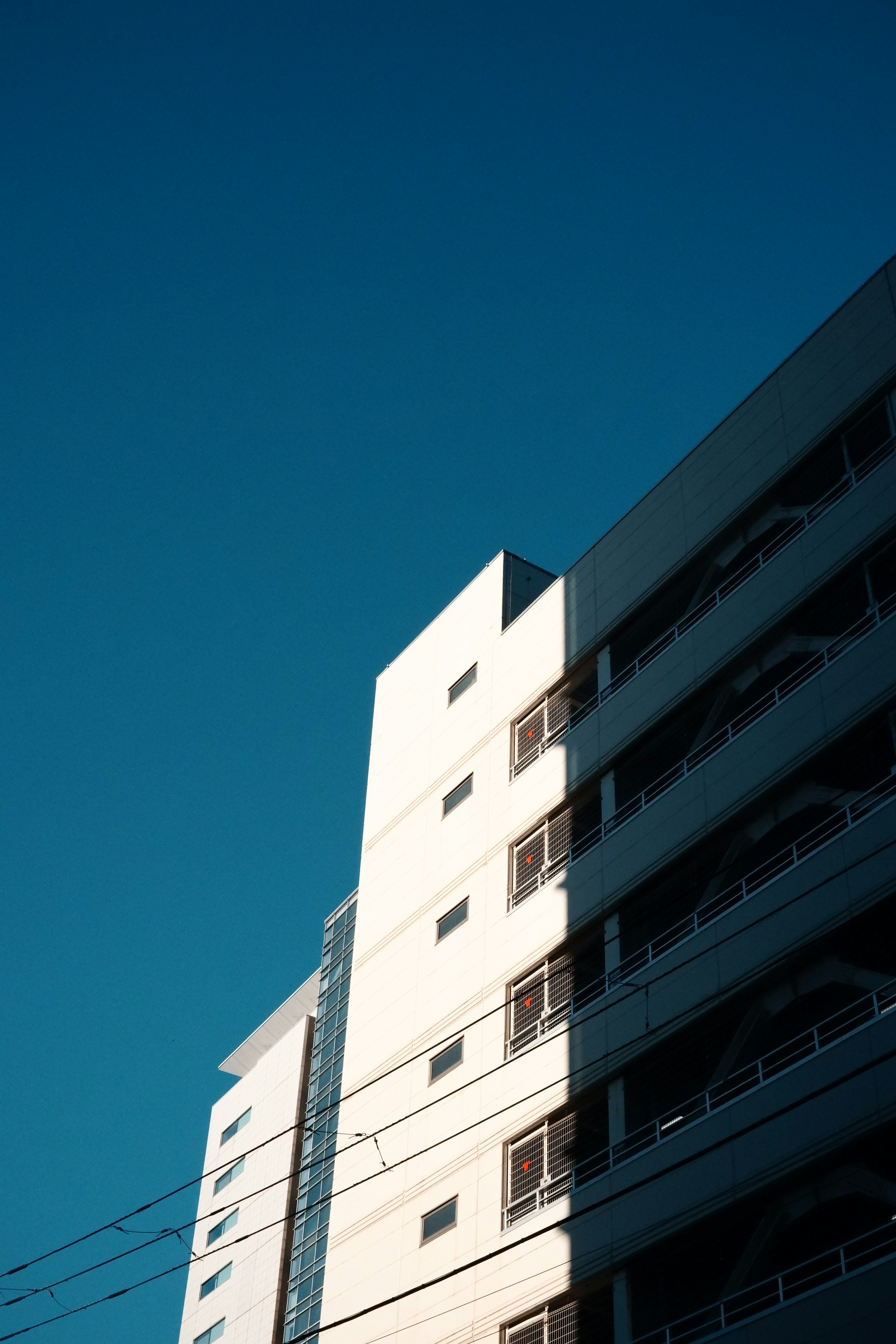 Modern white building side under clear blue sky