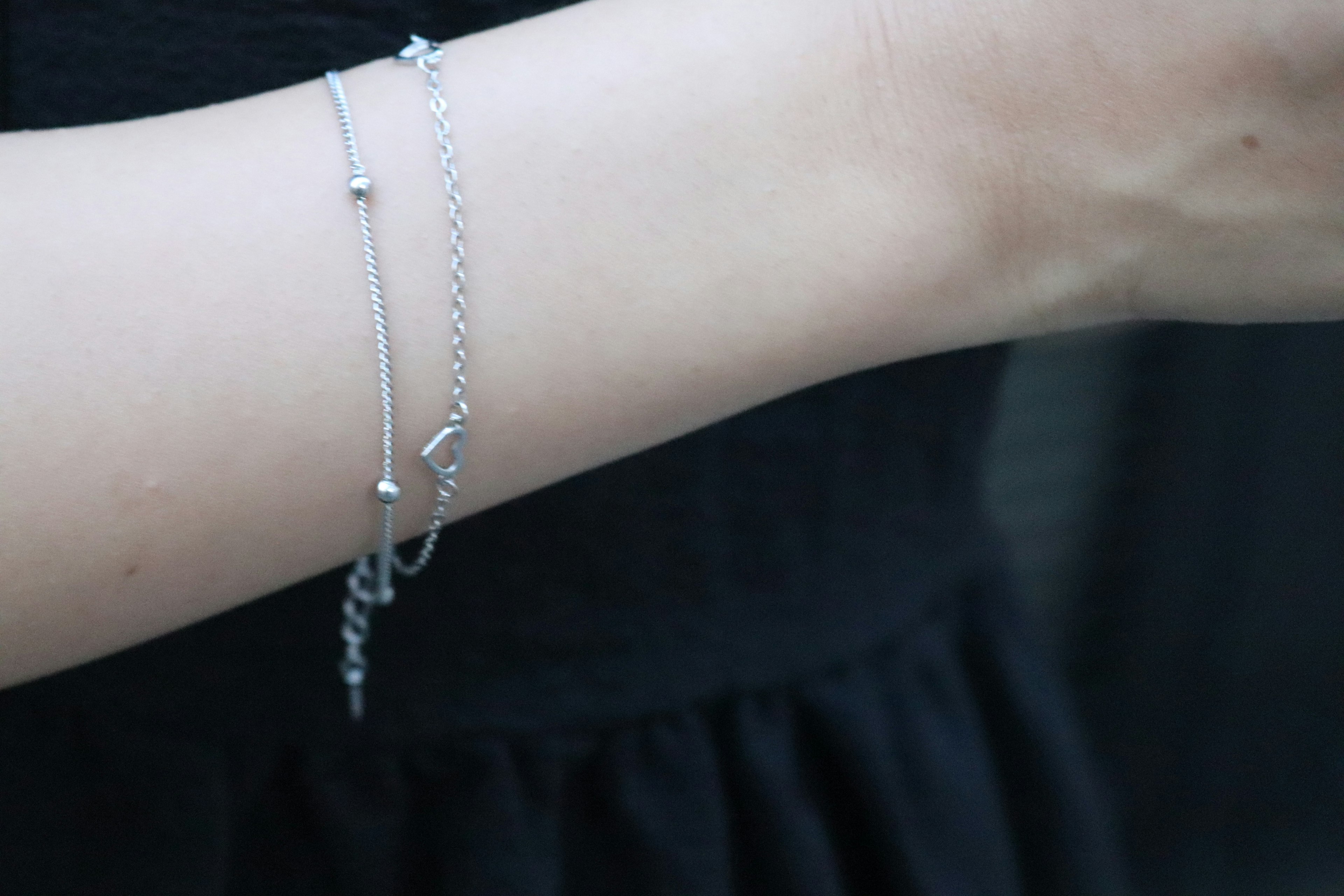 Close-up of an arm wearing silver bracelets