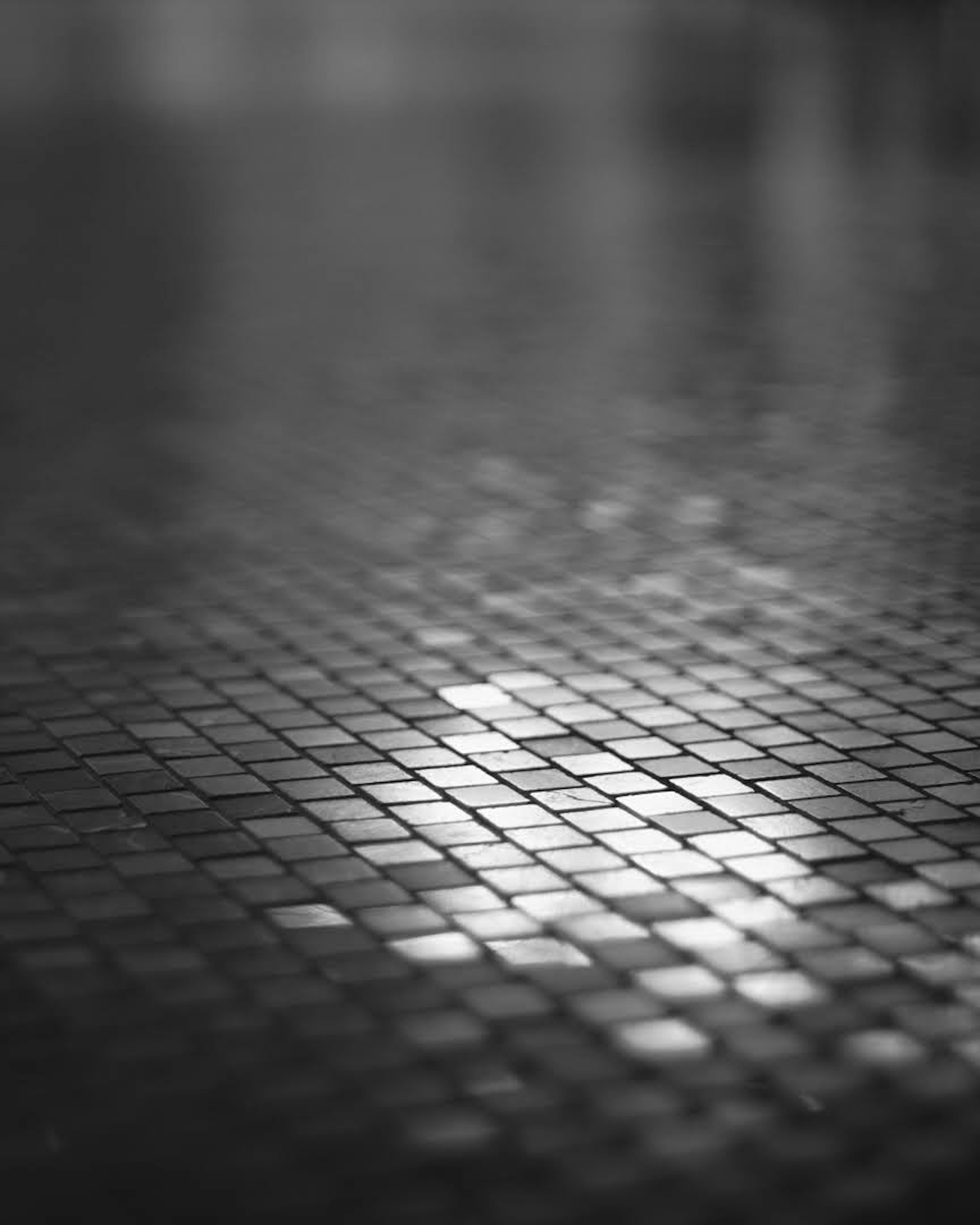 Black and white tiled floor reflecting light