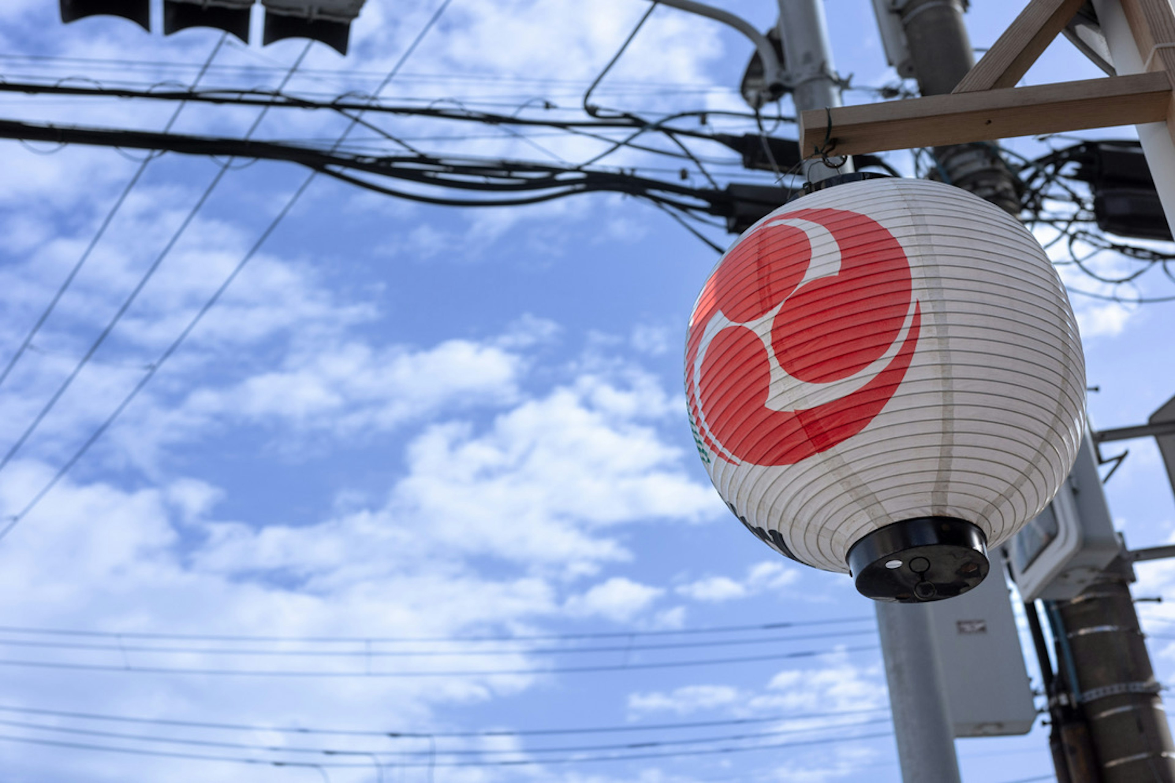 Street scene featuring a lantern hanging under a blue sky