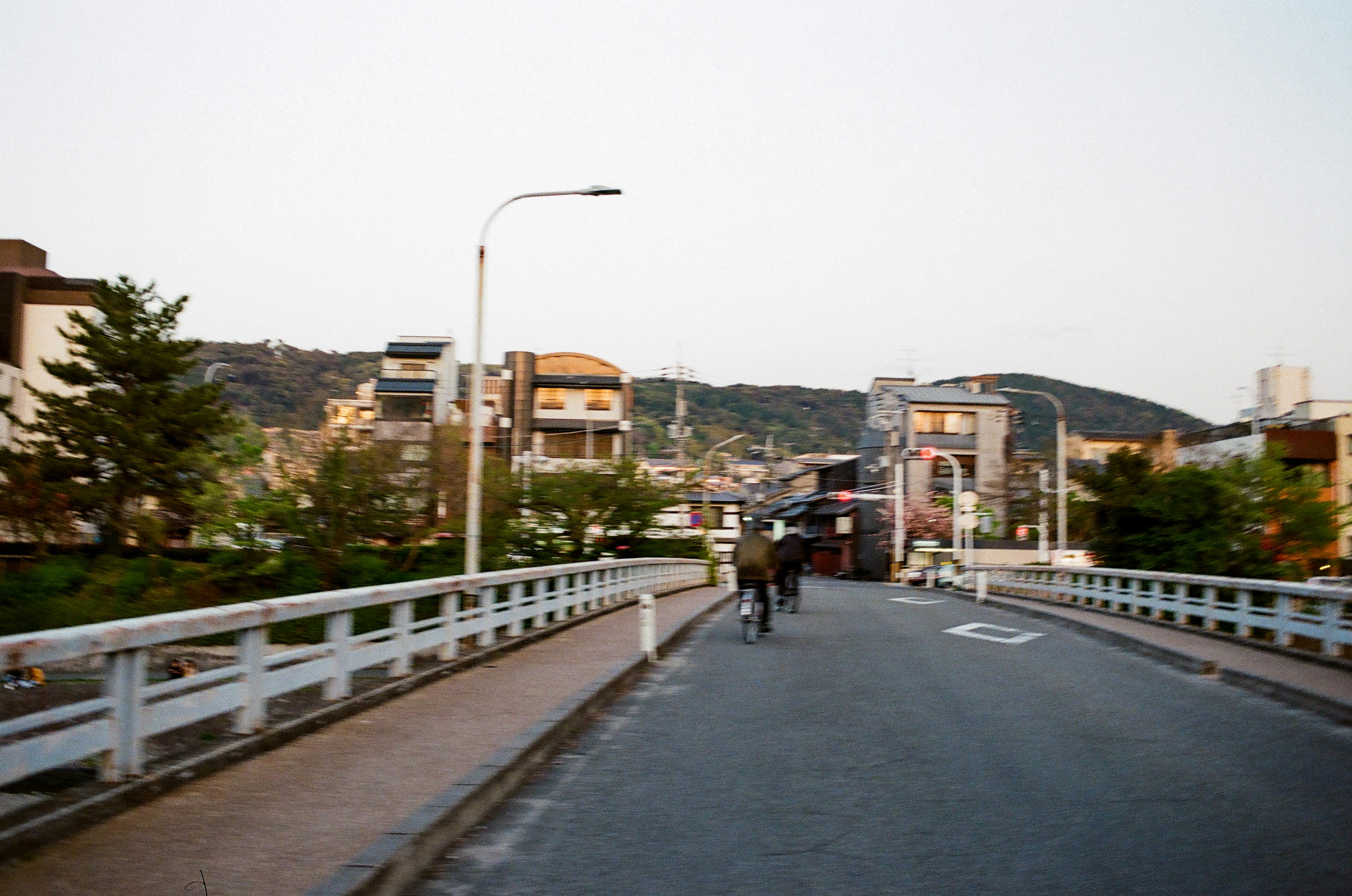 View of a bridge with people walking and surrounding buildings