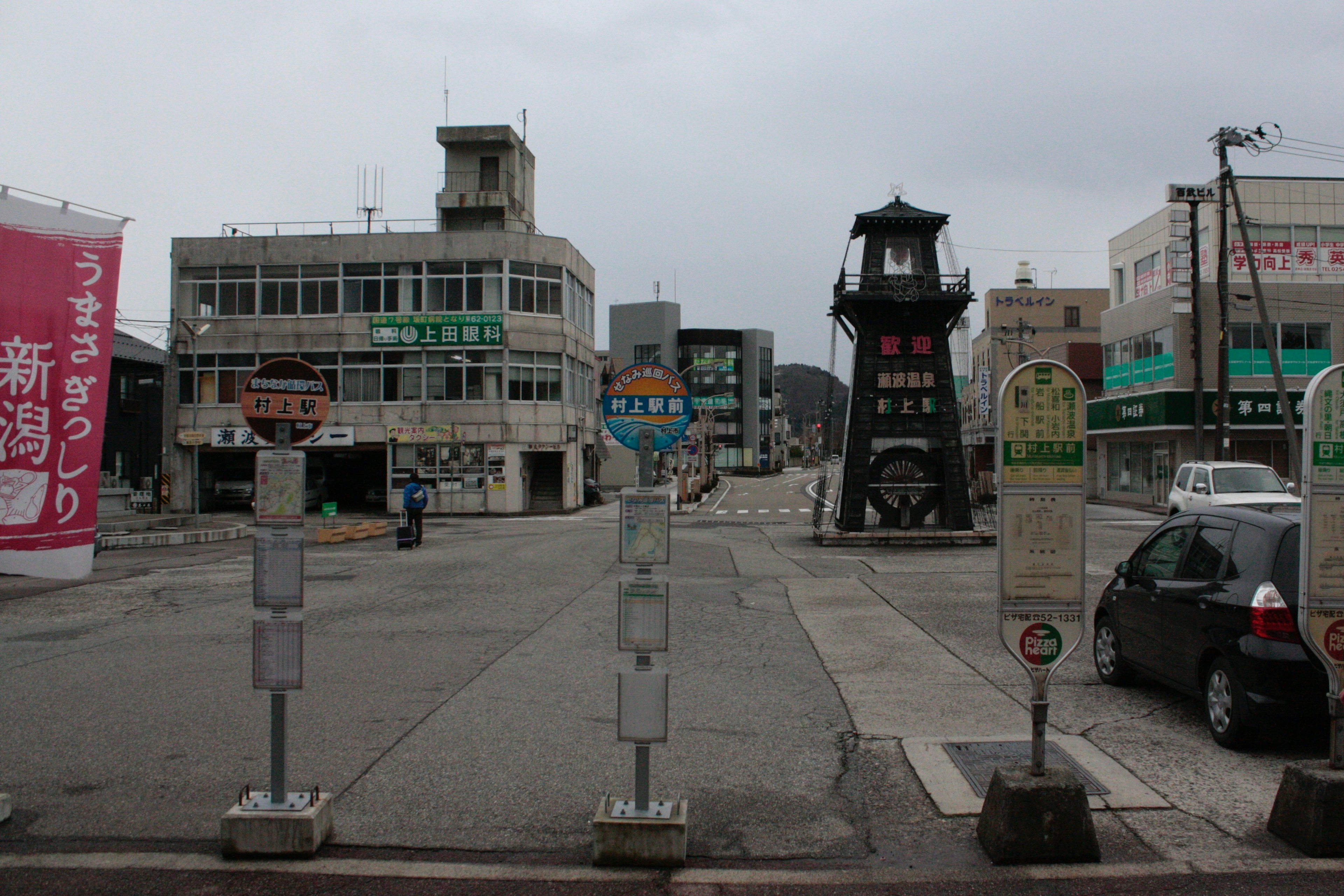 Quiet street scene featuring an old clock tower