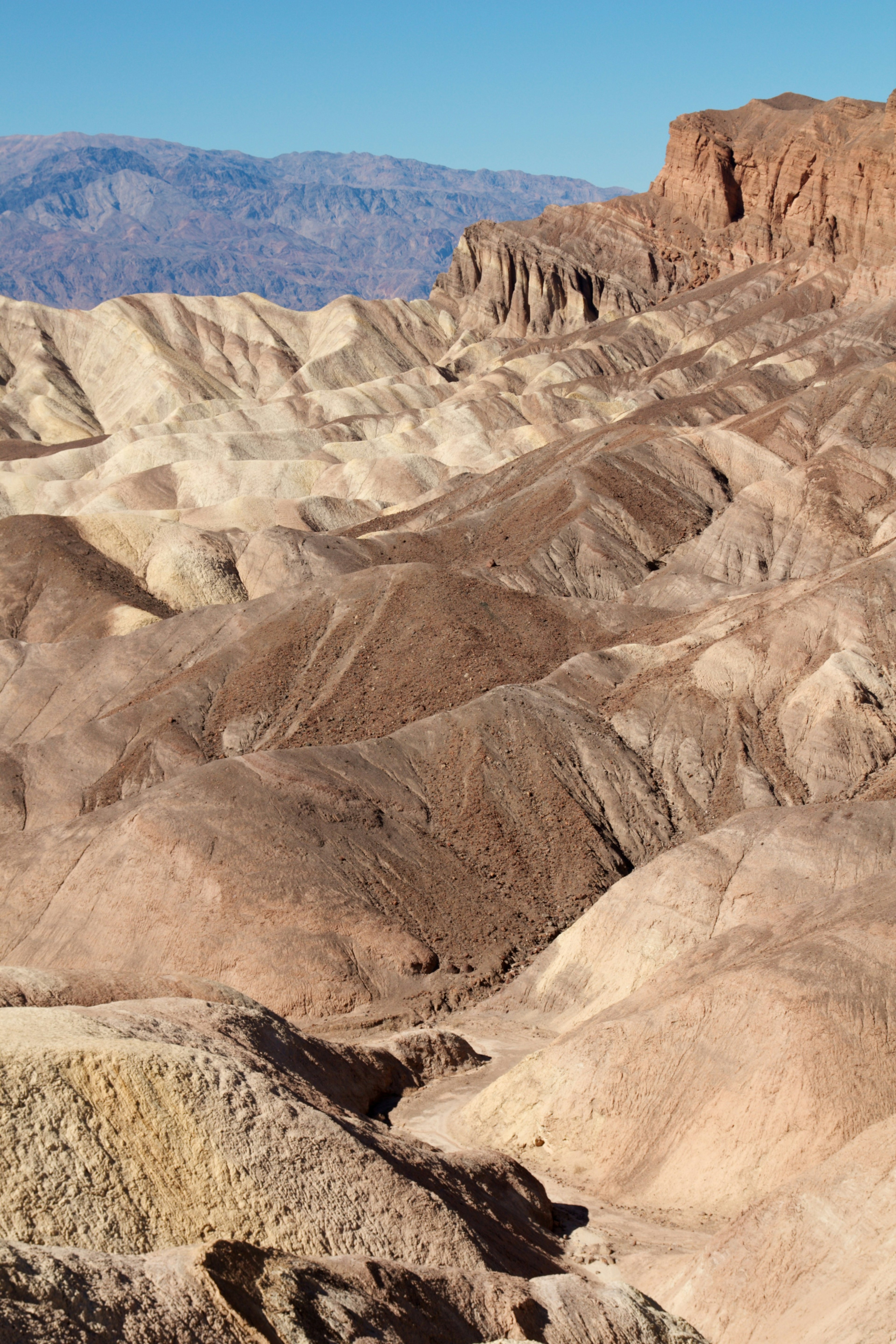 Wüstenlandschaft des Death Valley mit geschichteten Farben und trockenem Terrain