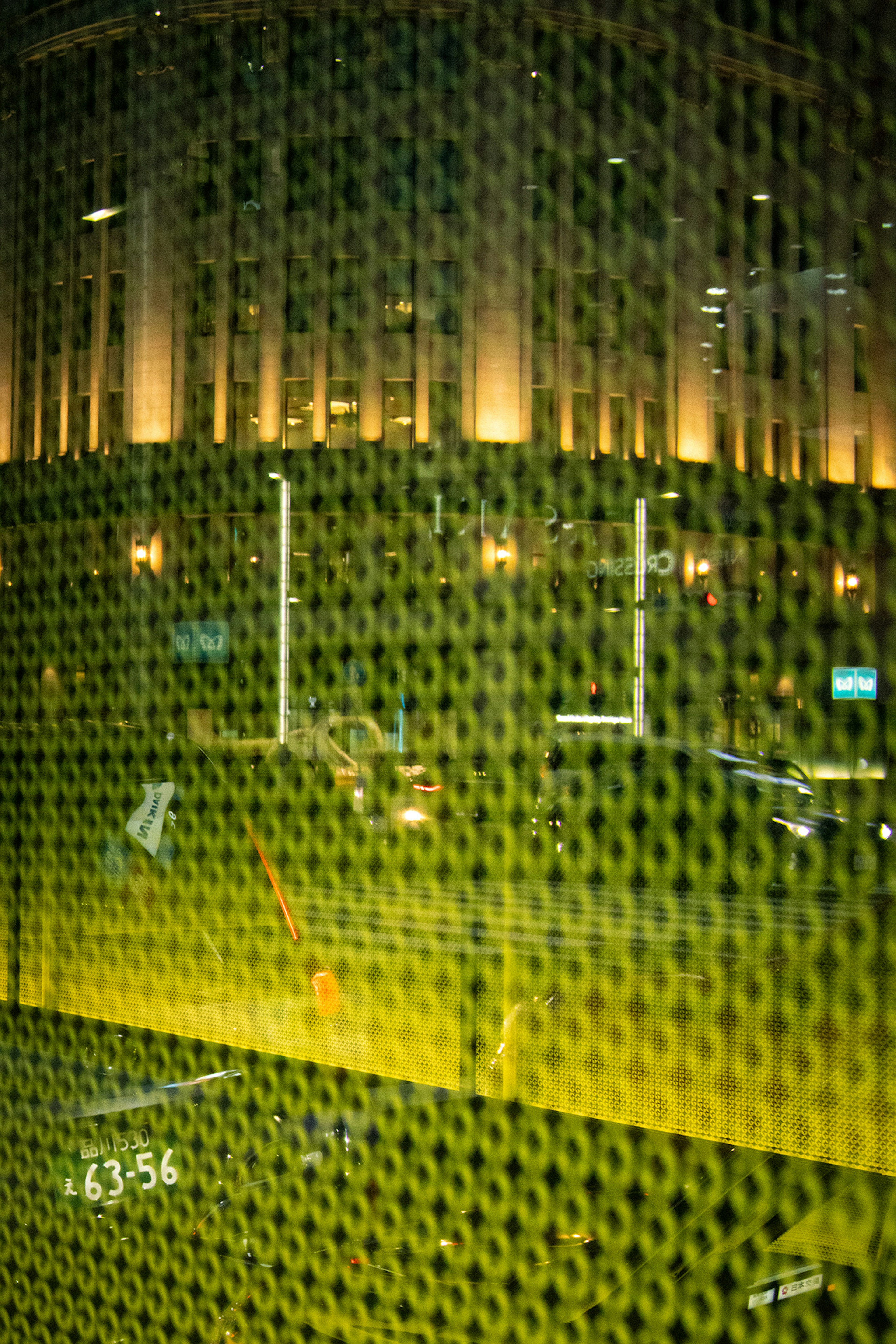 Bright yellow mesh pattern against a dark background with building lights