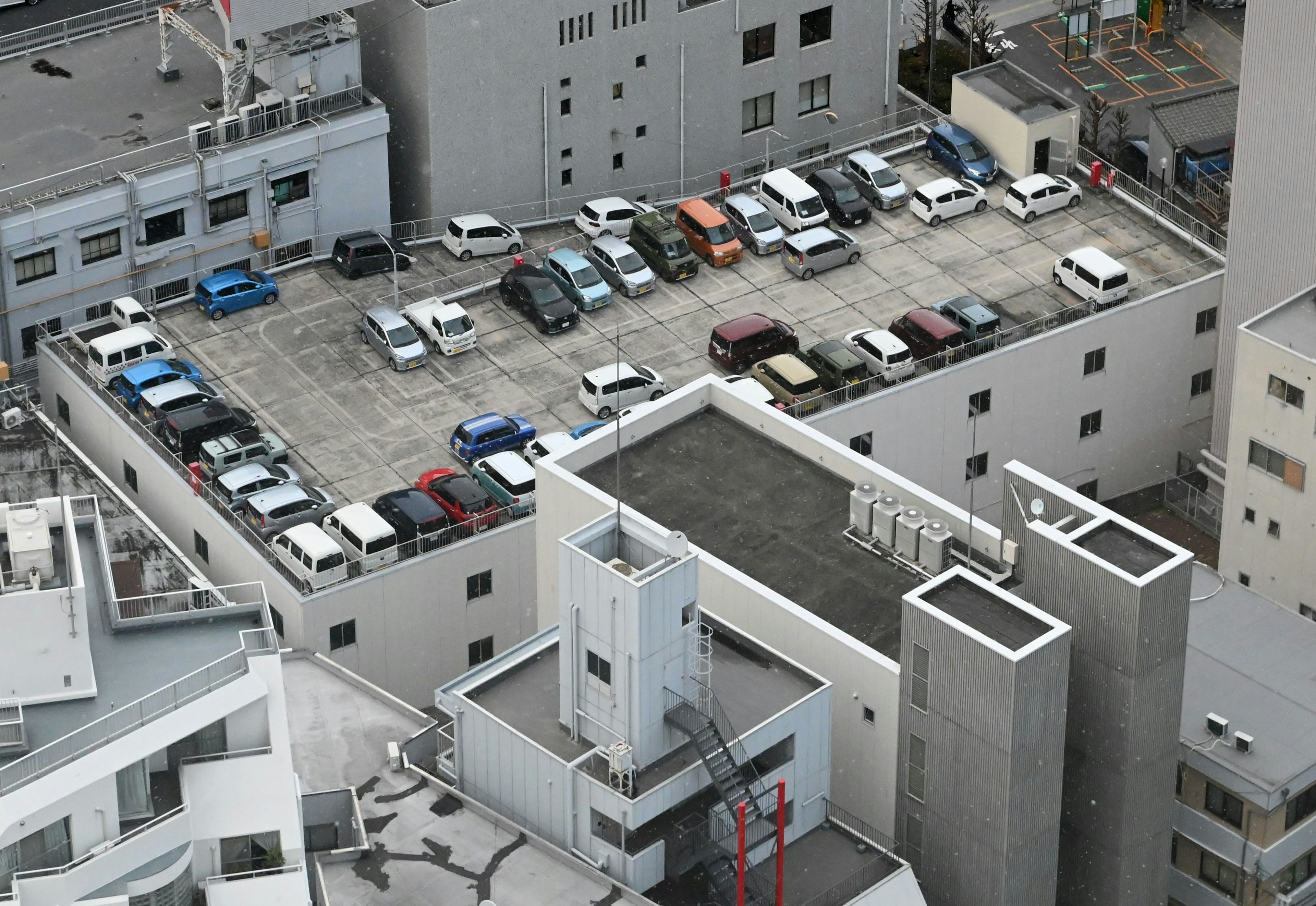 Aerial view of a parking lot with various vehicles arranged