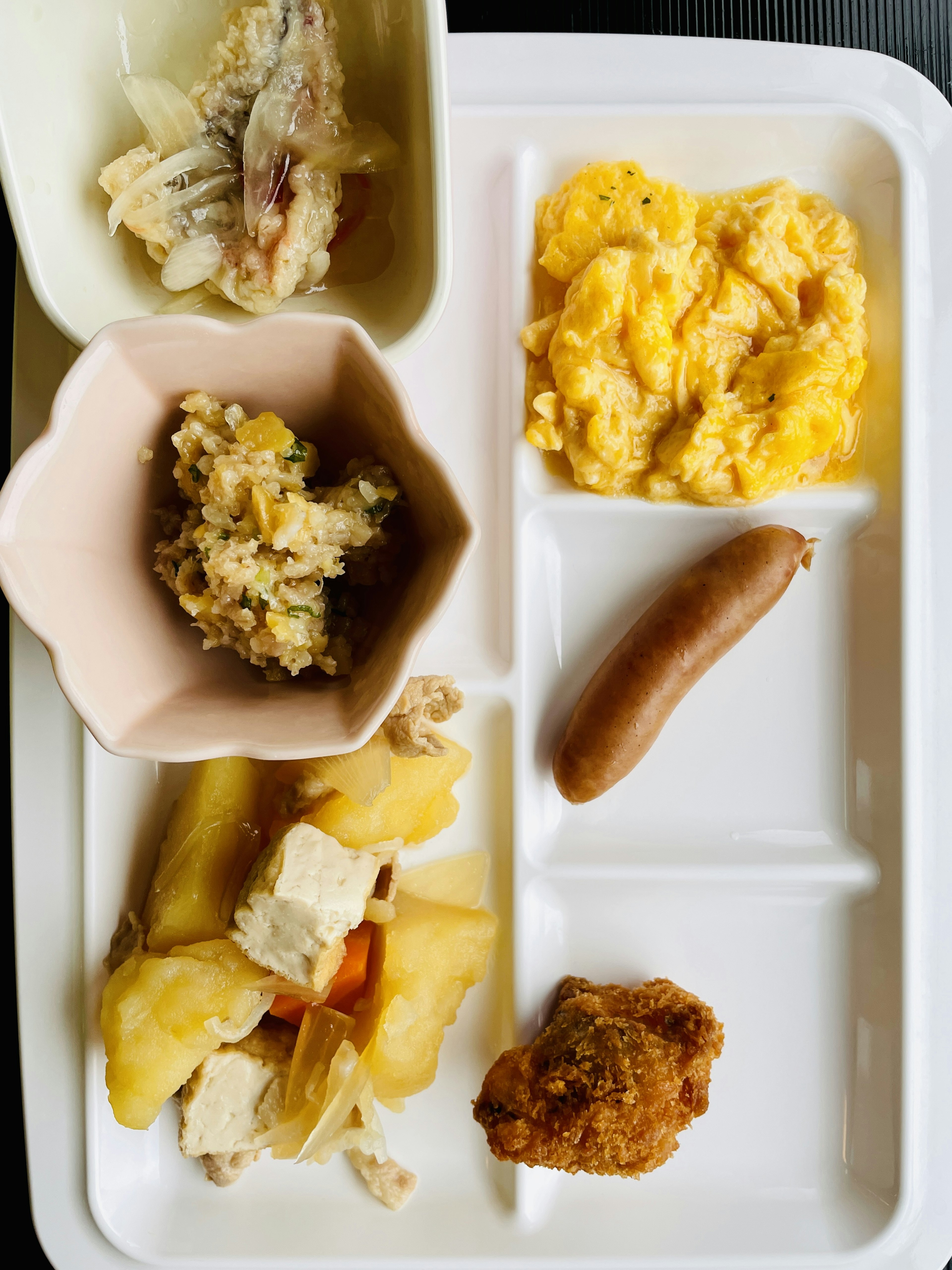 A variety of dishes arranged on a white tray