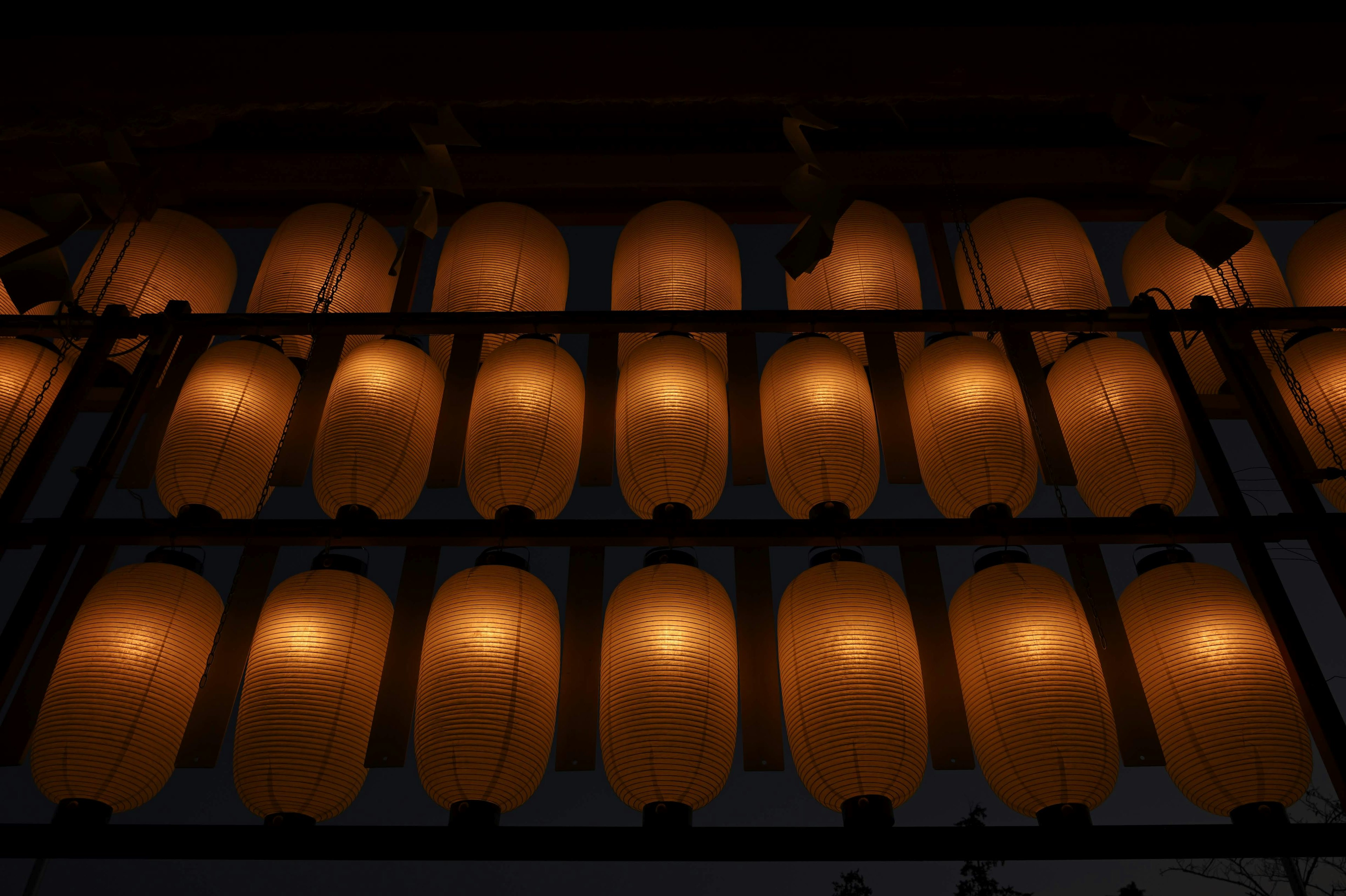 A row of Japanese lanterns emitting warm light