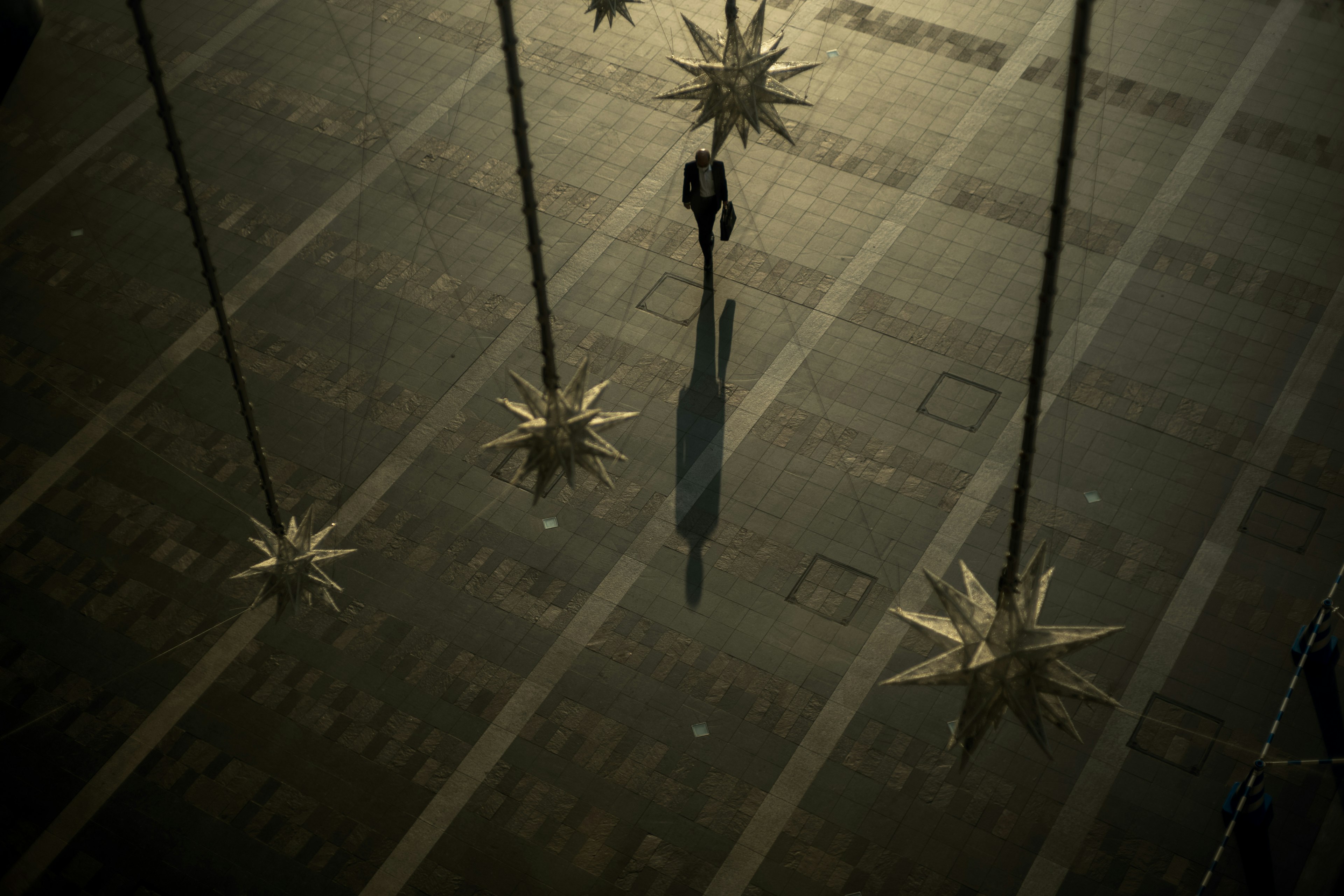 A person standing in a dimly lit space with star-shaped decorations