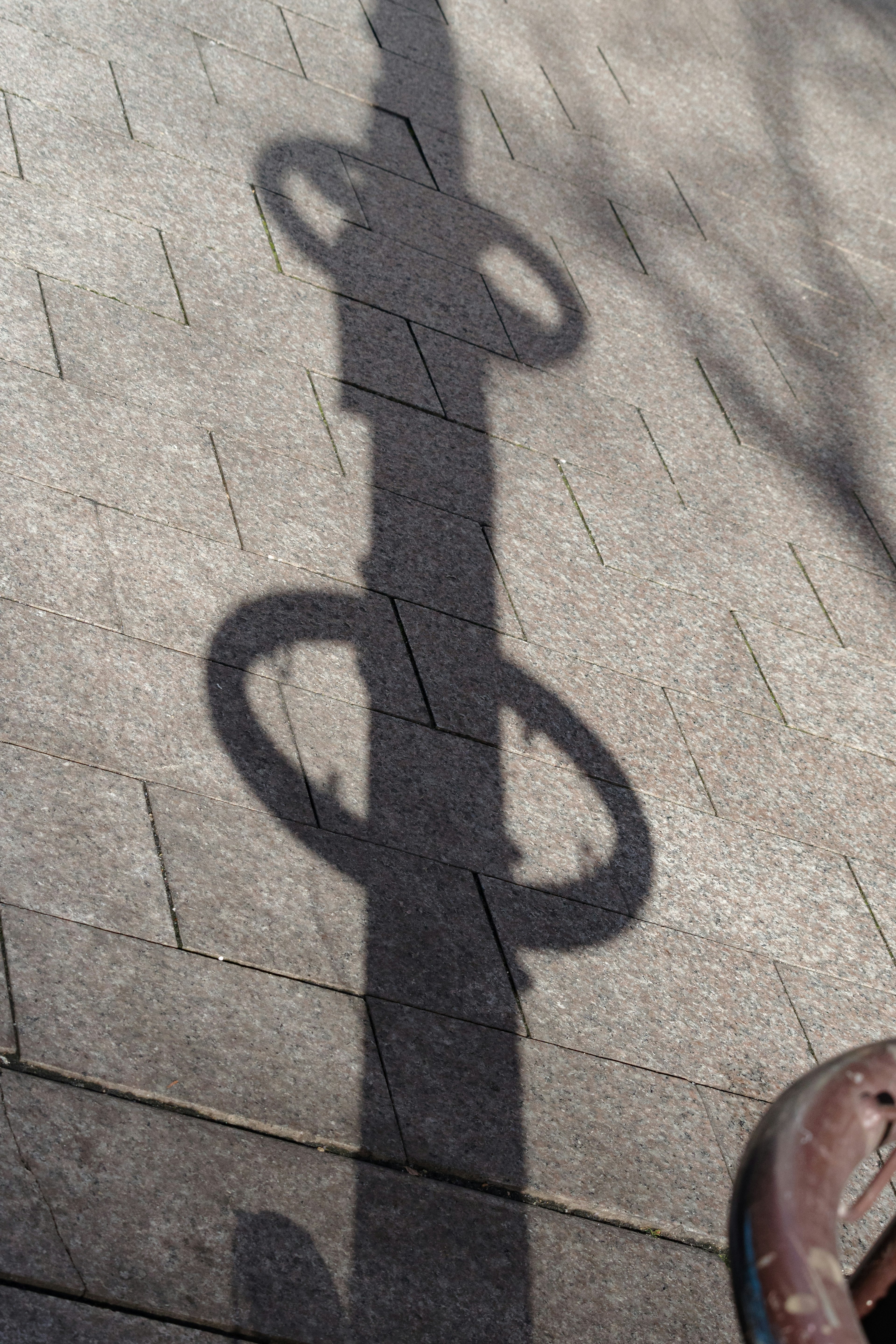 Unique circular shapes created by shadow on pavement