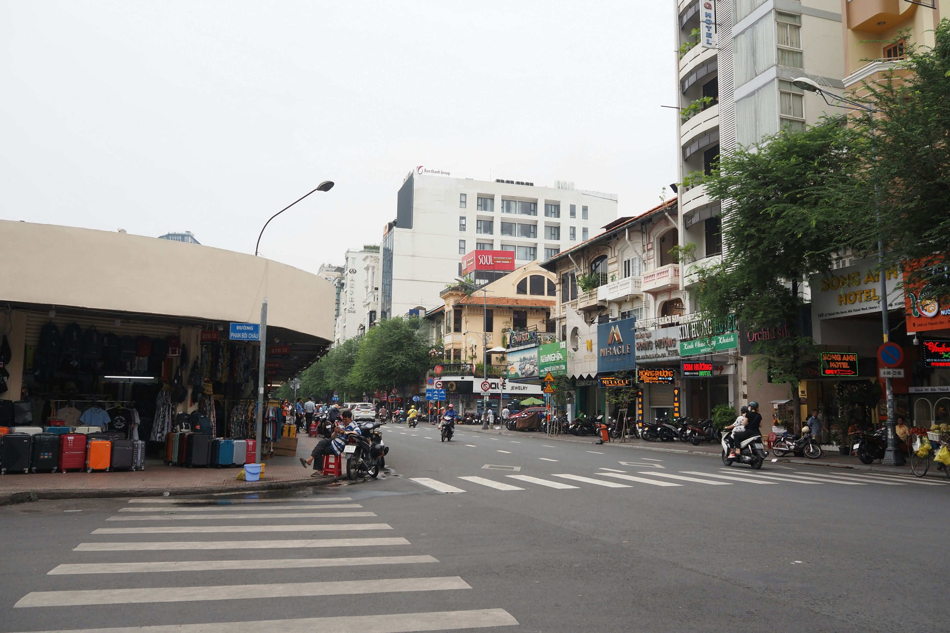 Street view showing a crossroad with buildings and pedestrians