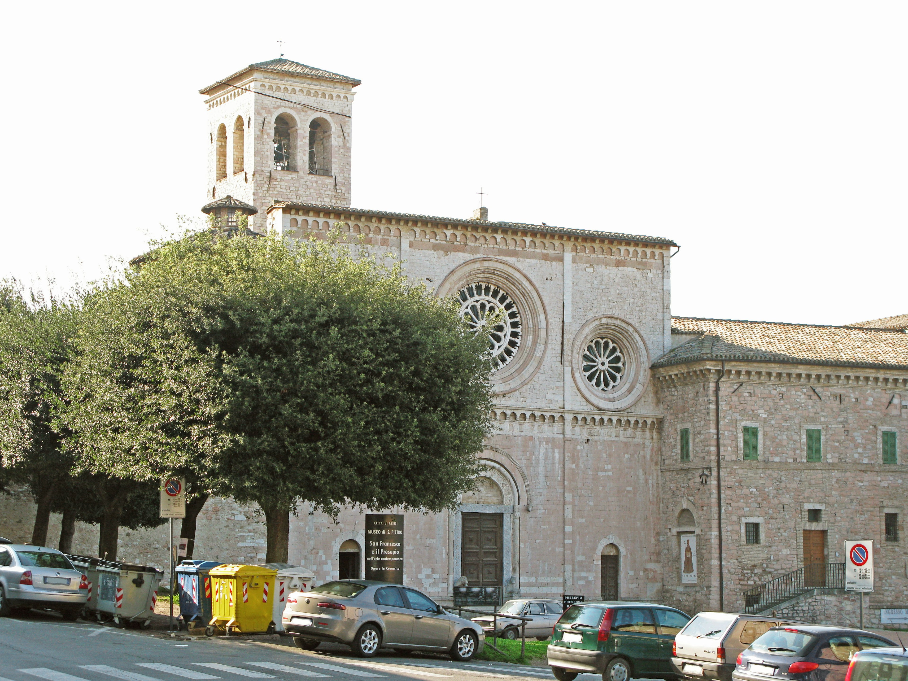 Historic church facade with large tree