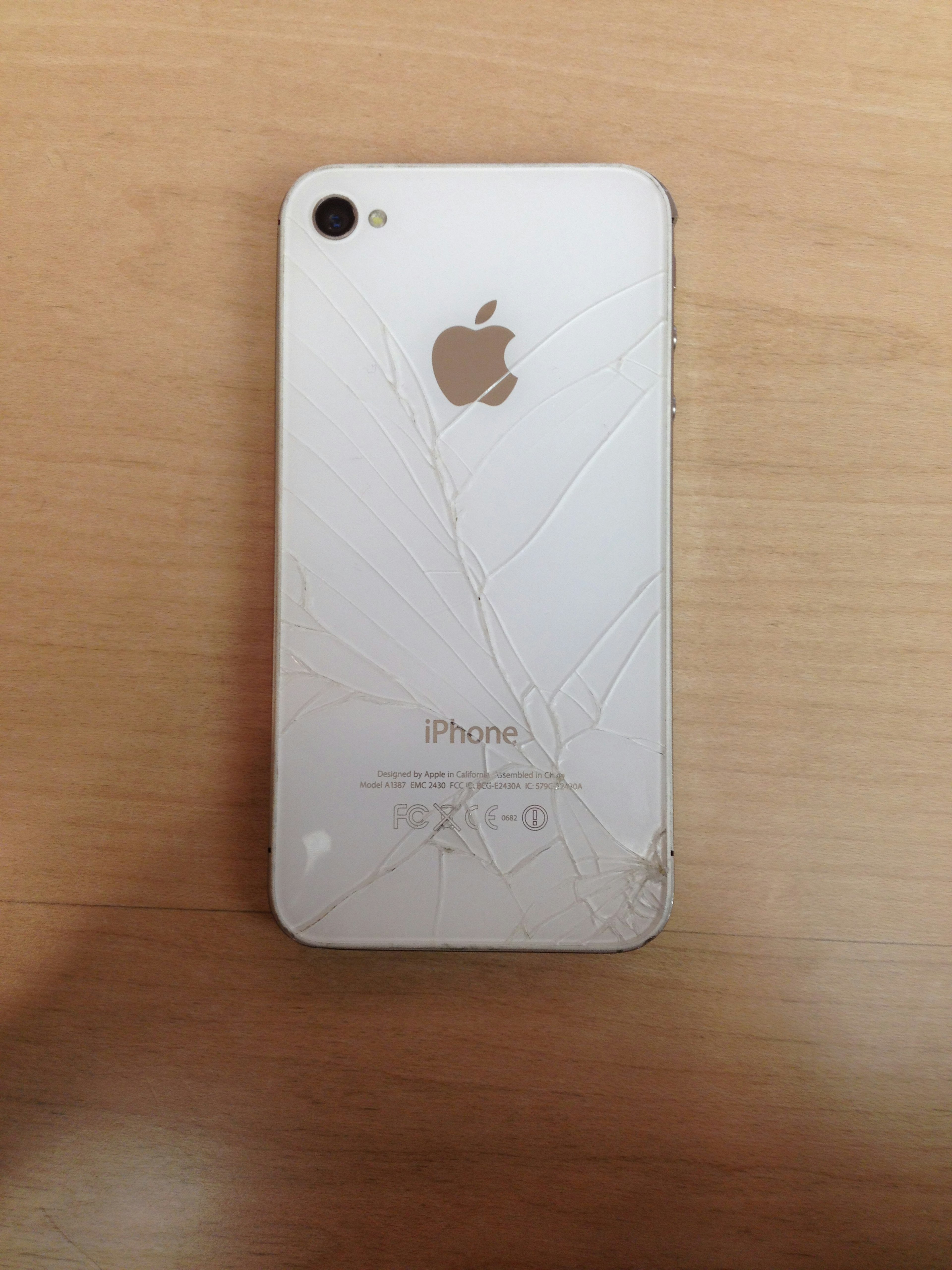 Photo of a cracked white iPhone