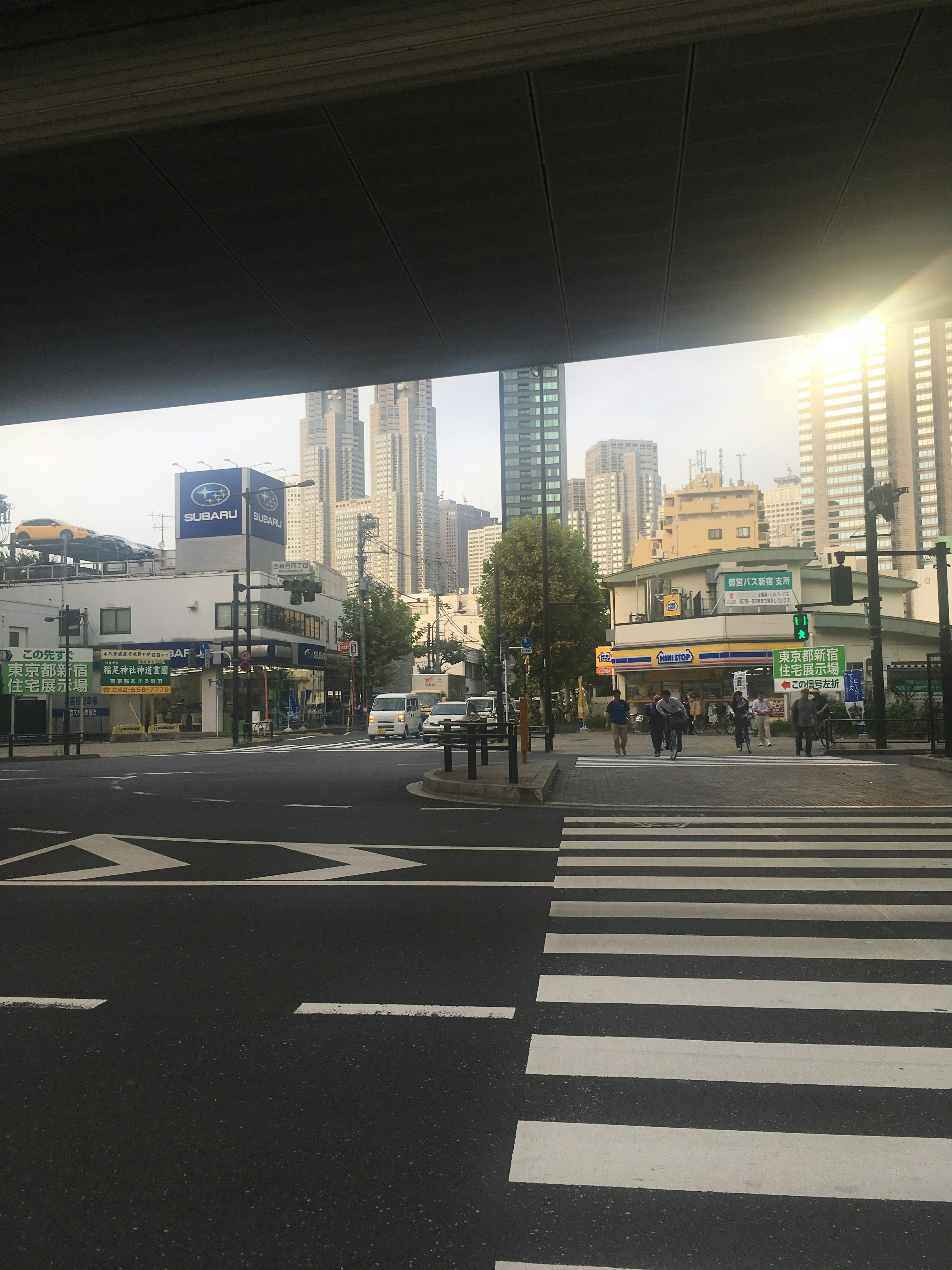 Urban intersection view with skyscrapers in the background pedestrians crossing the street