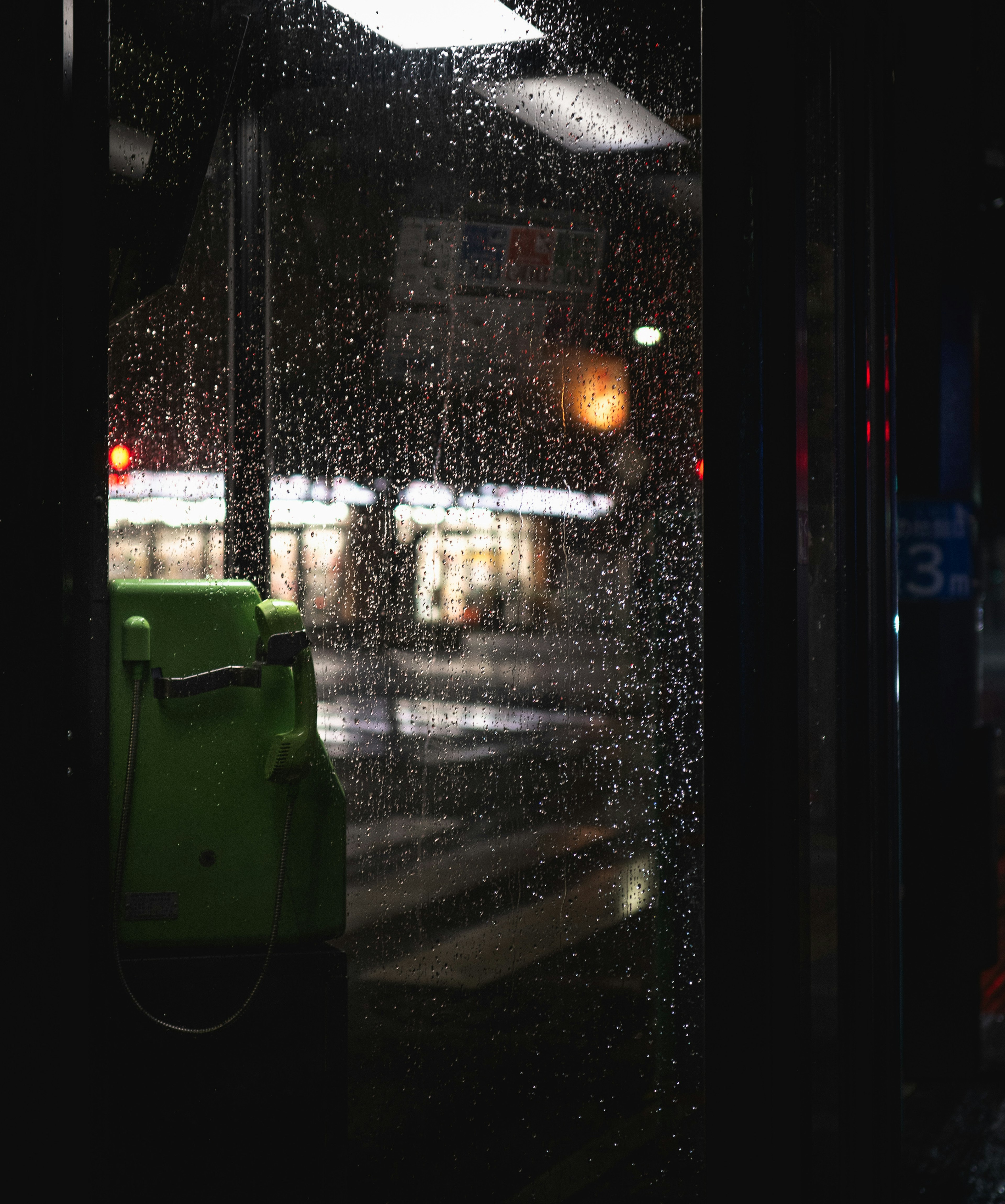 Night city view through a rain-soaked bus window