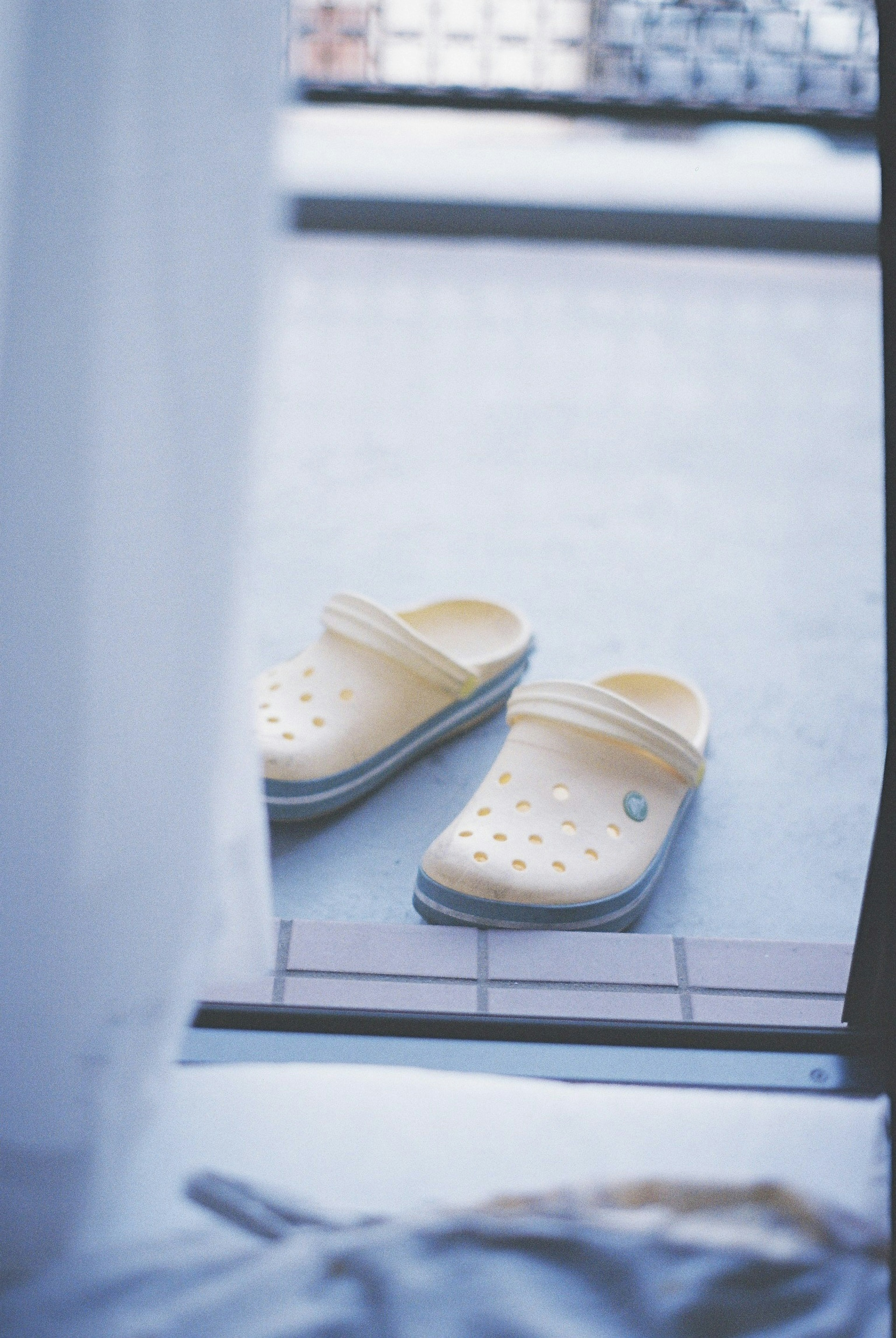 Yellow clogs placed at the doorway