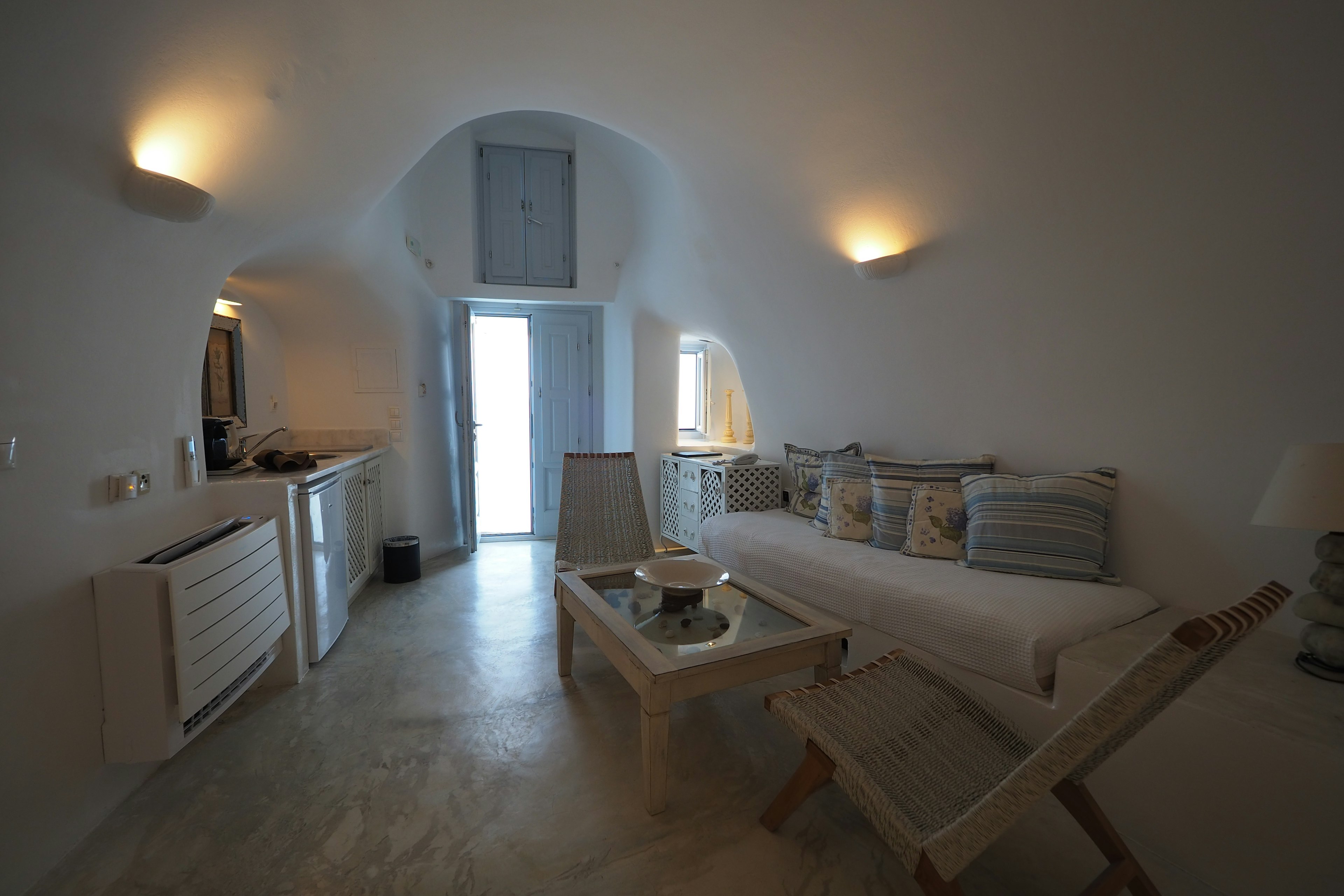 A living room with white walls and simple furniture interior