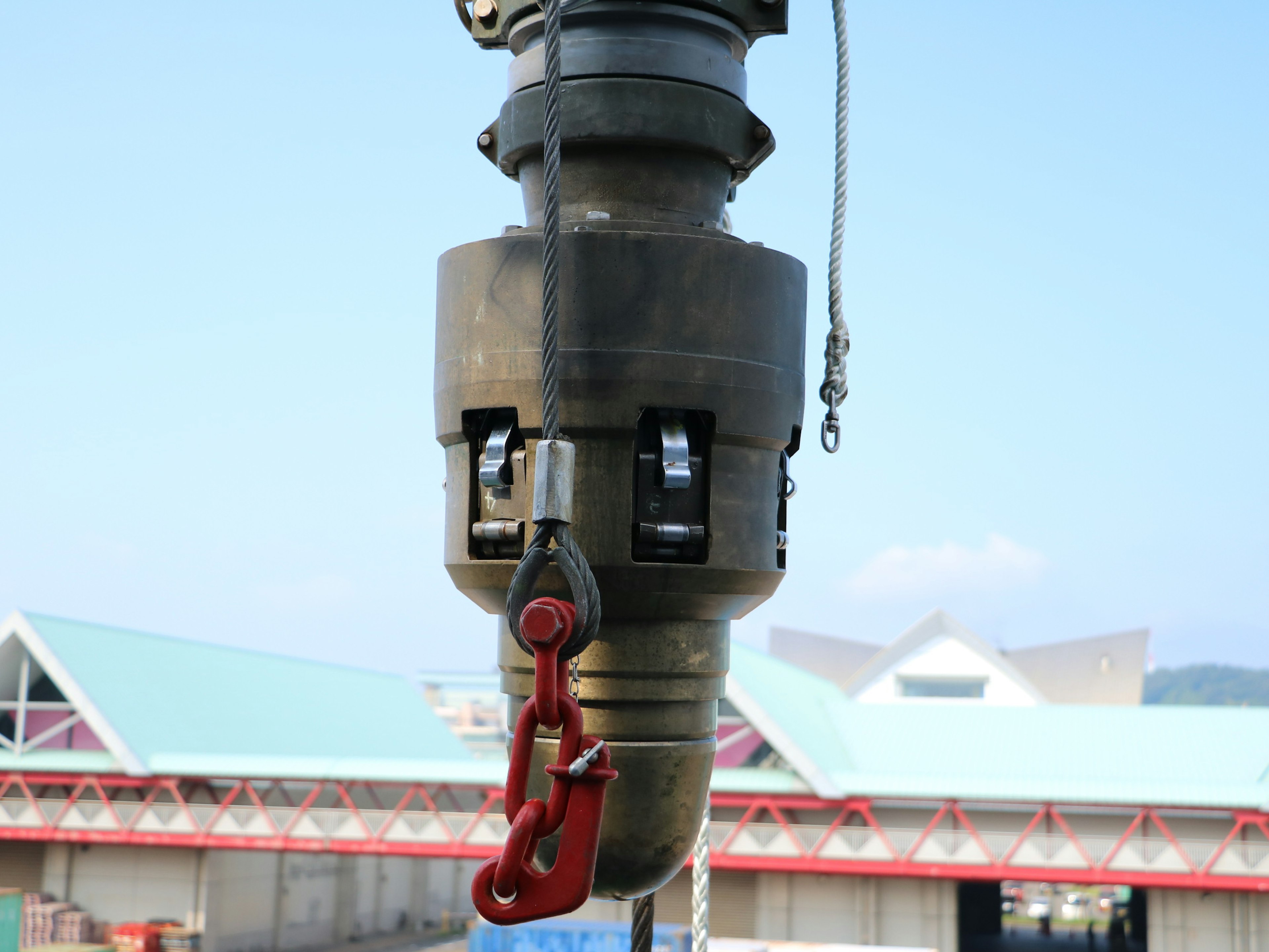 Close-up of a crane hook metal crane device red hook is prominent