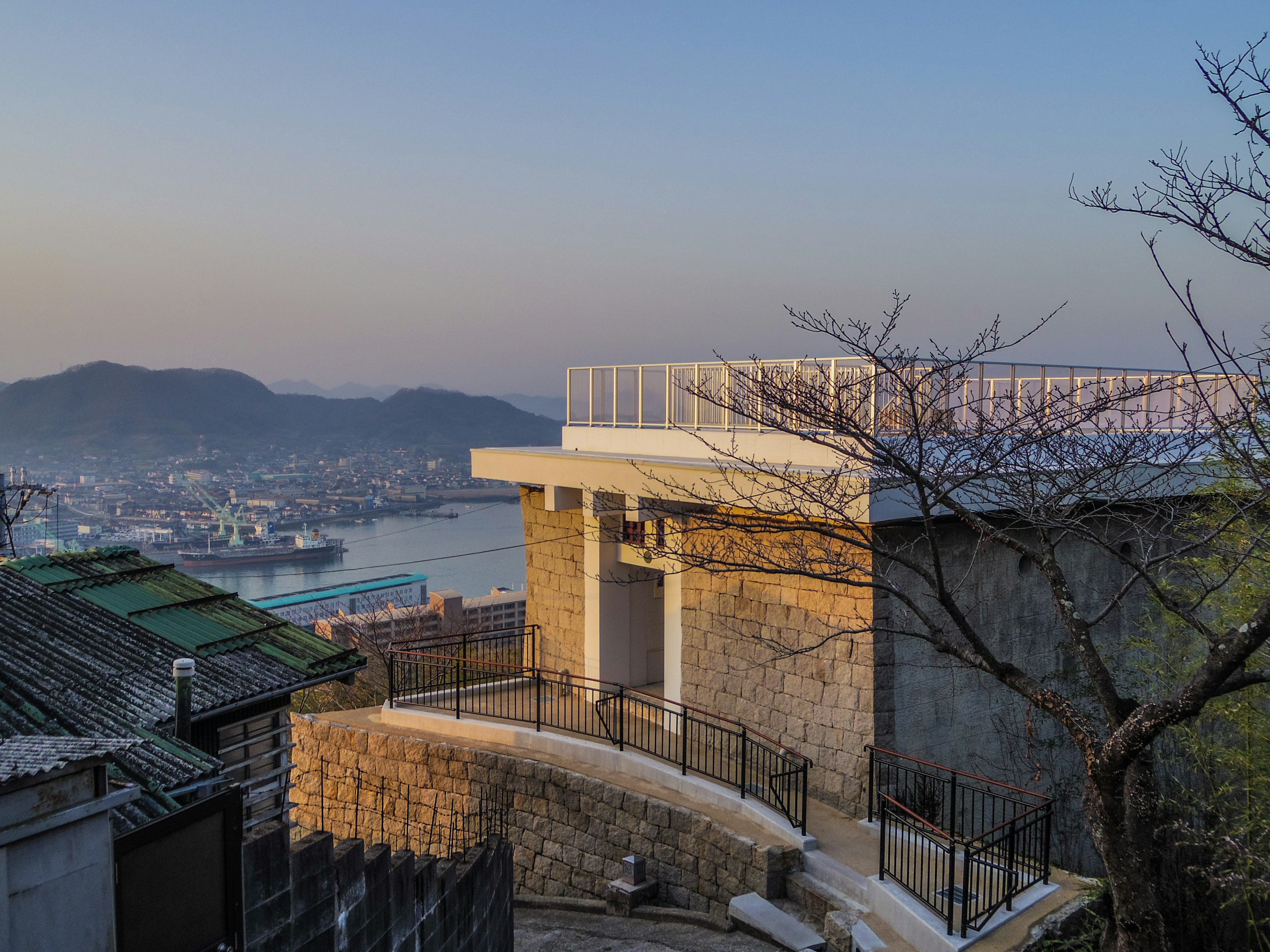 Modern building overlooking the sea with mountain scenery